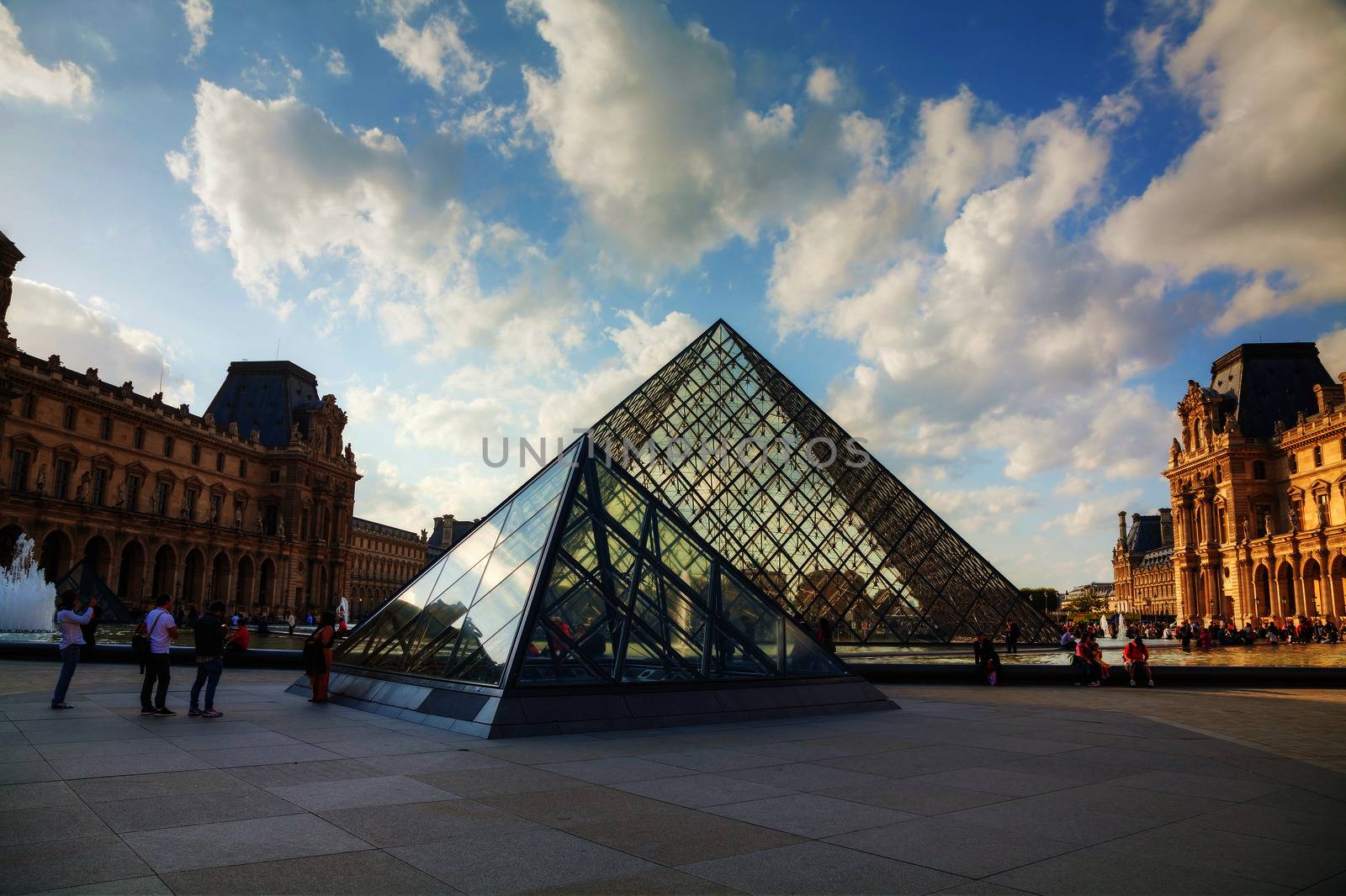 PARIS - OCTOBER 9: The Louvre Pyramid on October 9, 2014 in Paris, France. It serves as the main entrance to the Louvre Museum. Completed in 1989 it has become a landmark of Paris.