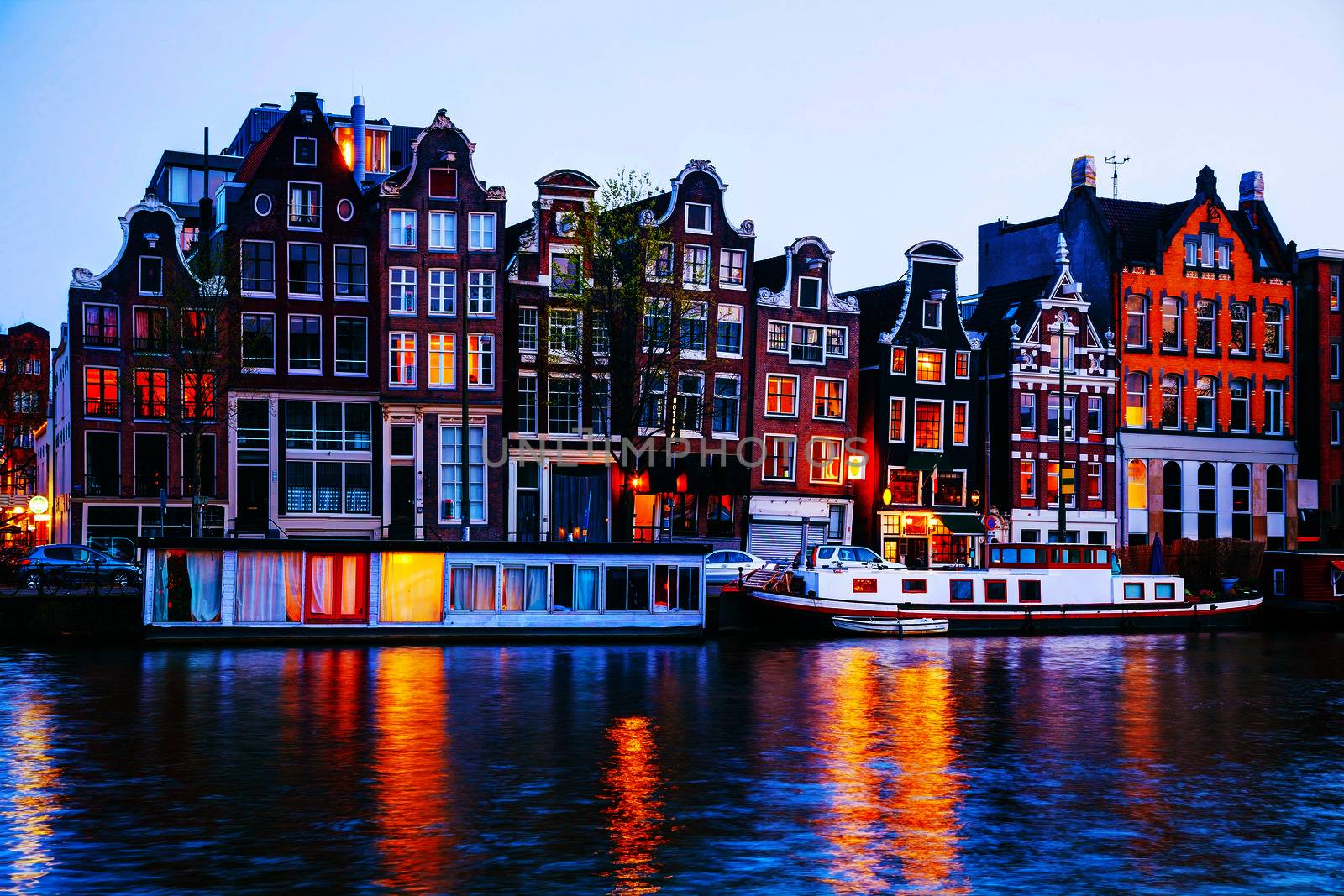 Night city view of Amsterdam, the Netherlands with Amstel river