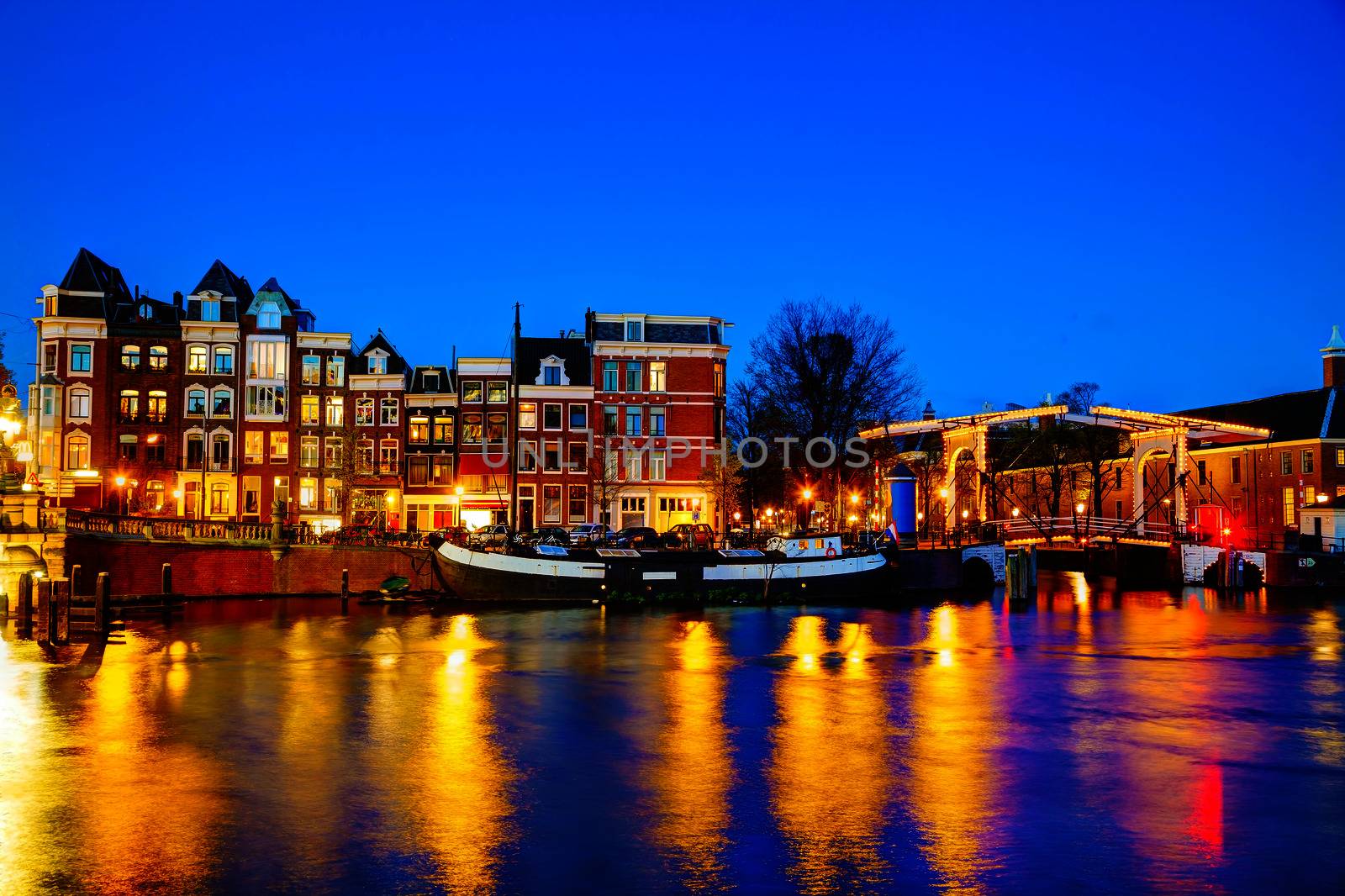 Night city view of Amsterdam, the Netherlands with Amstel river