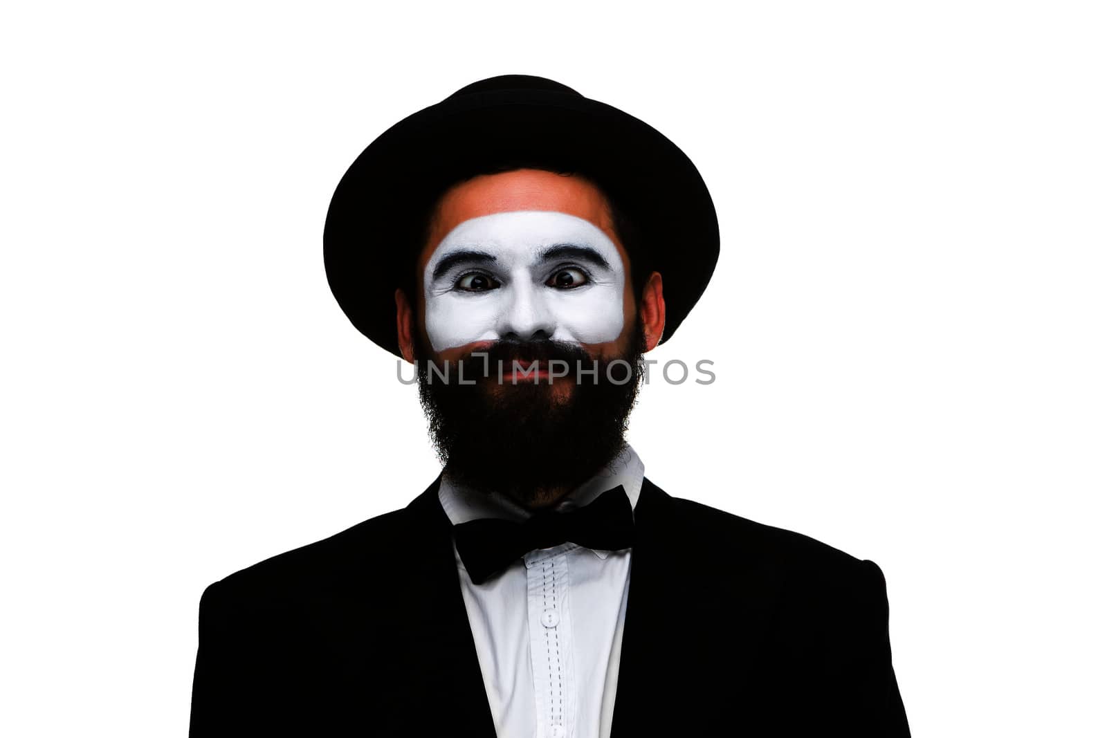 Portrait of the surprised mime with squinting eyes isolated on white background. Concept of wonder and expectation