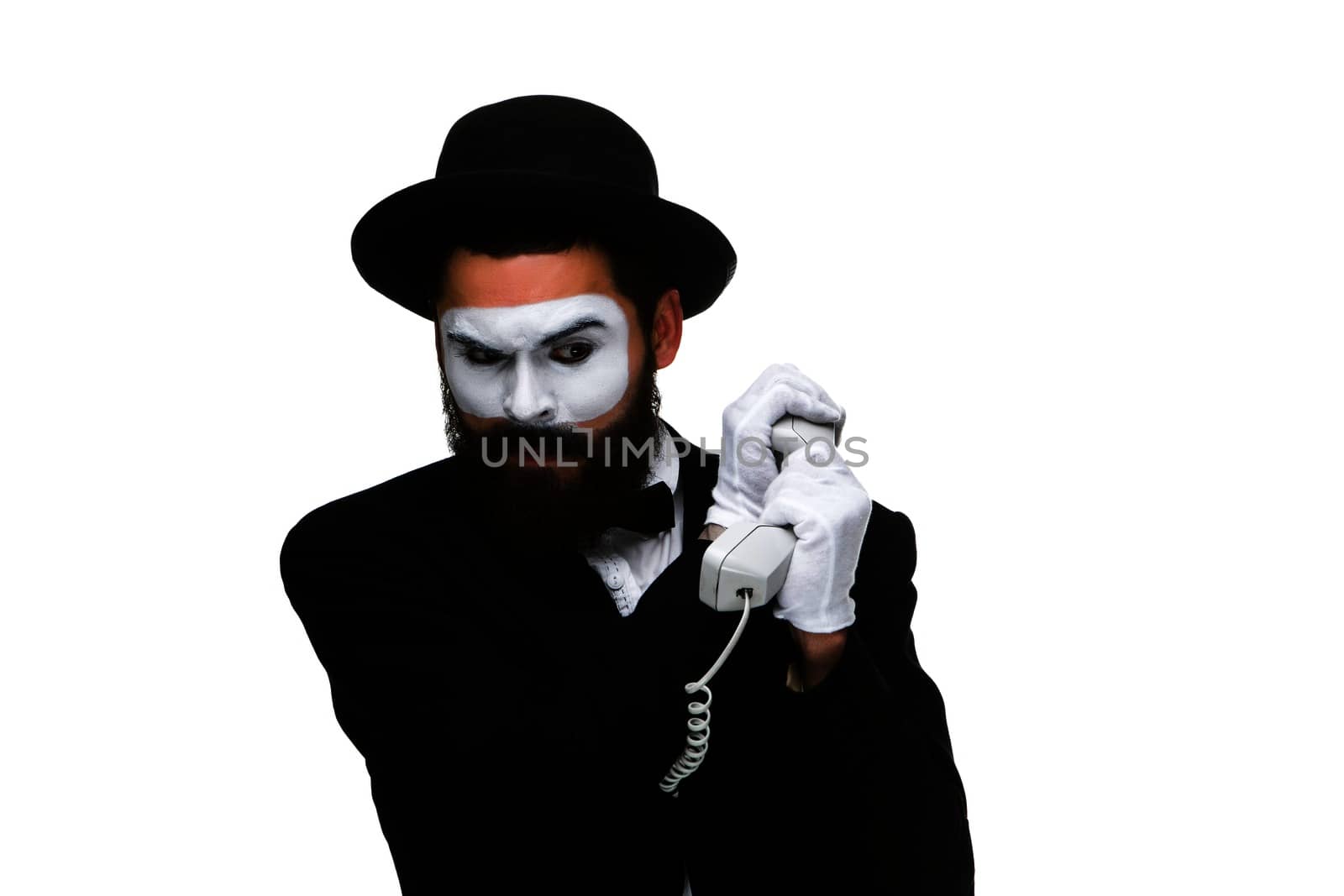 man in the image mime holding a handset isolated on white background. The concept -  I do not want to hear