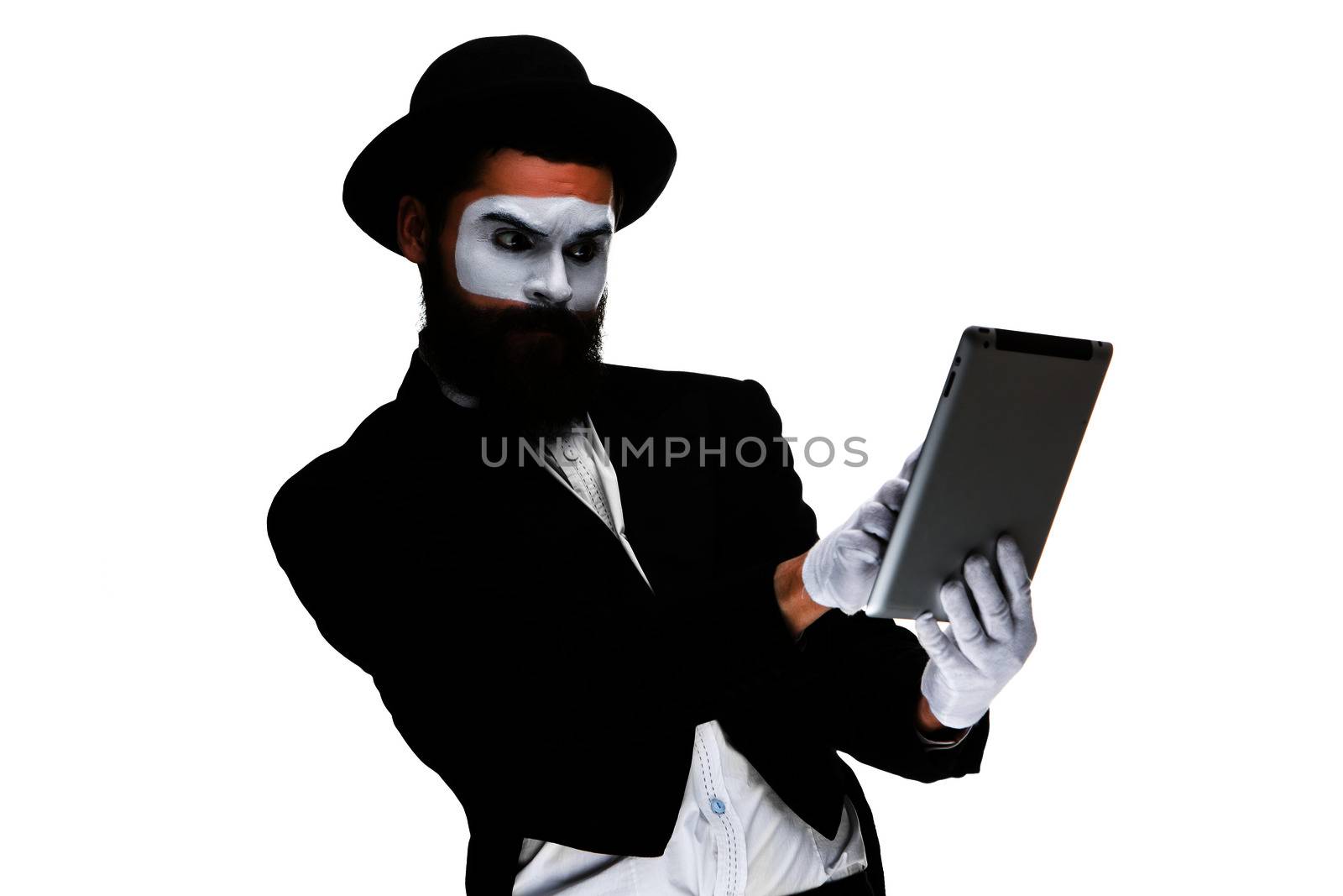 Man with a face mime working on a laptop isolated on a white background. concept of thinking in business