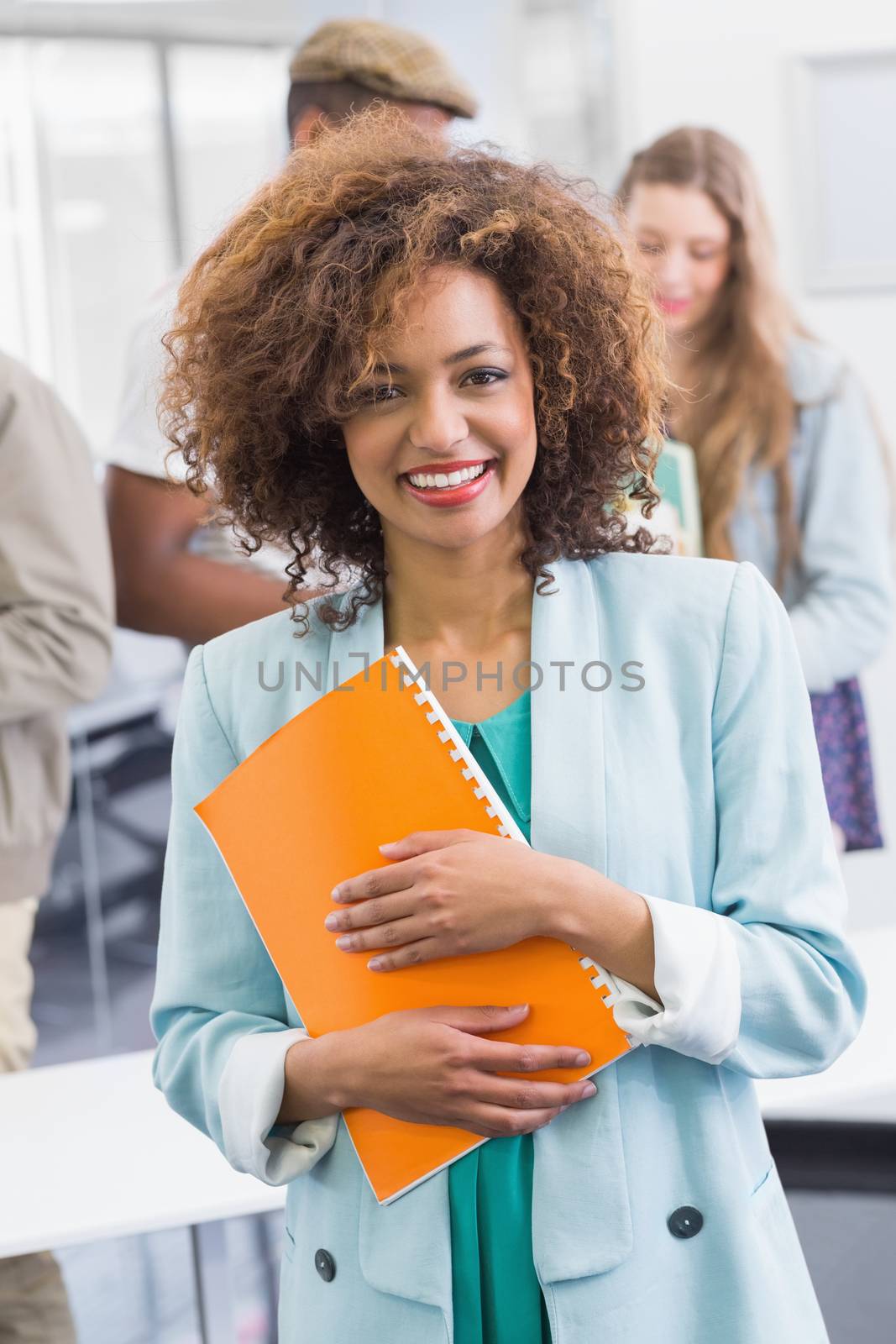 Fashion student smiling at camera at the college