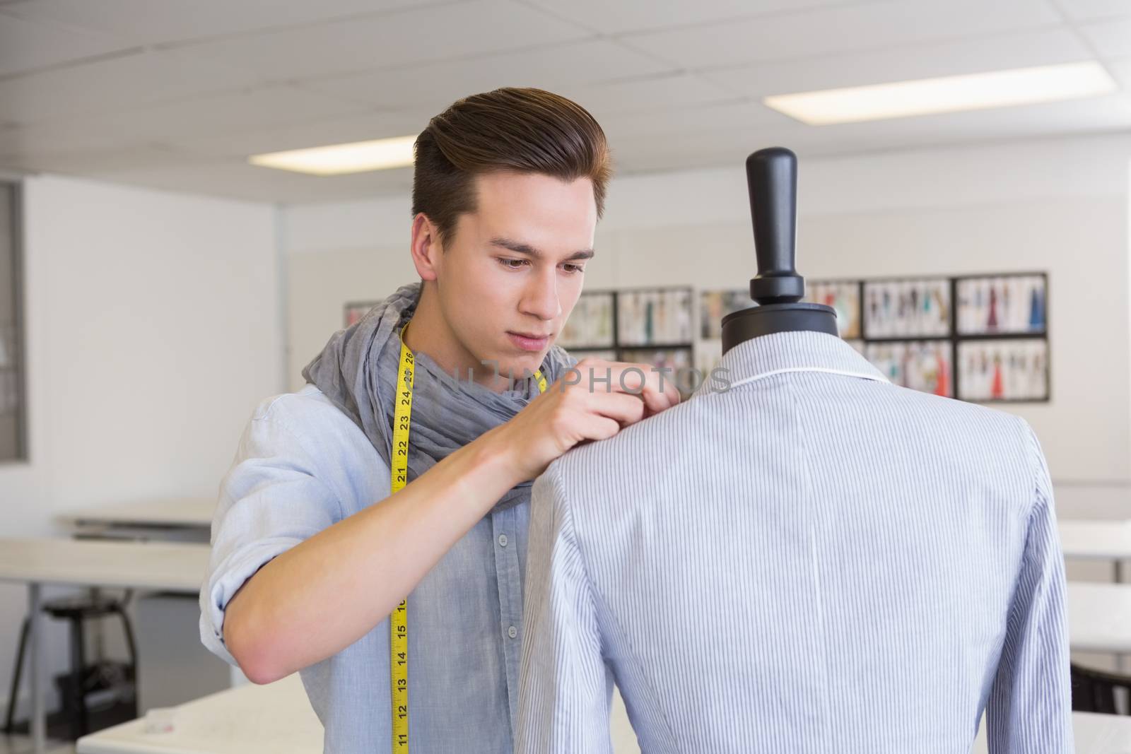 Fashion student working on mannequin at the college