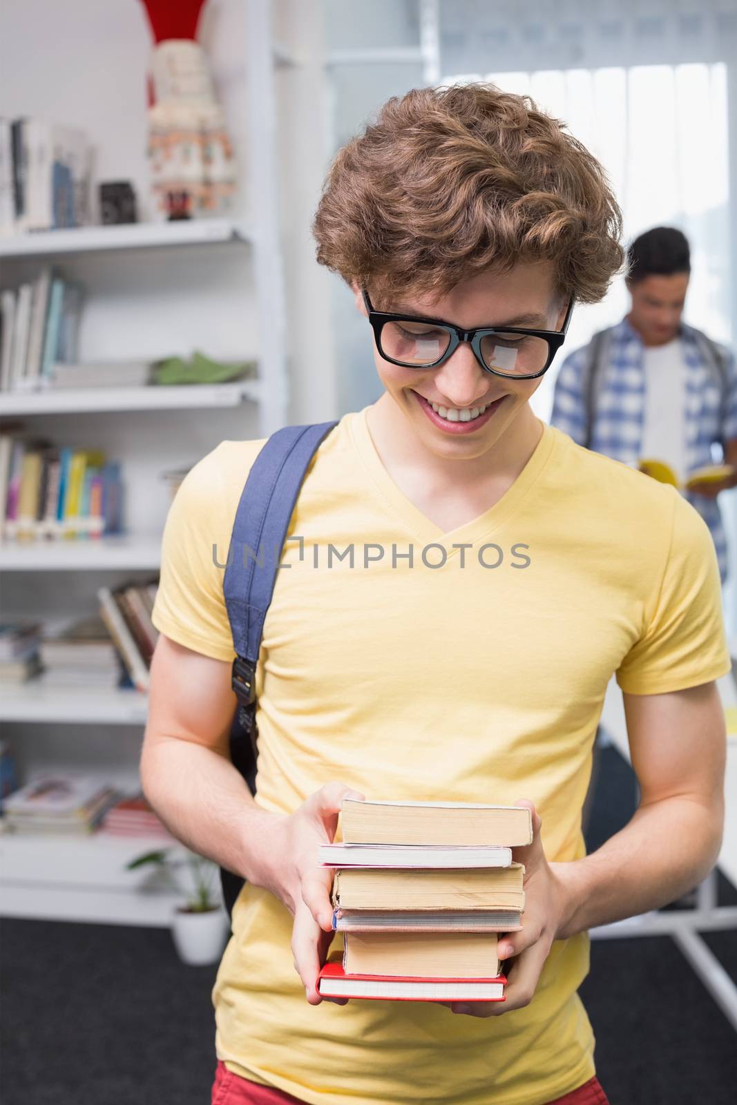 Students carrying small pile of books at the college