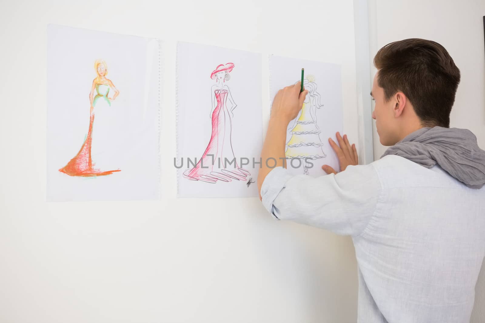 Fashion student drawing pictures on paper by Wavebreakmedia