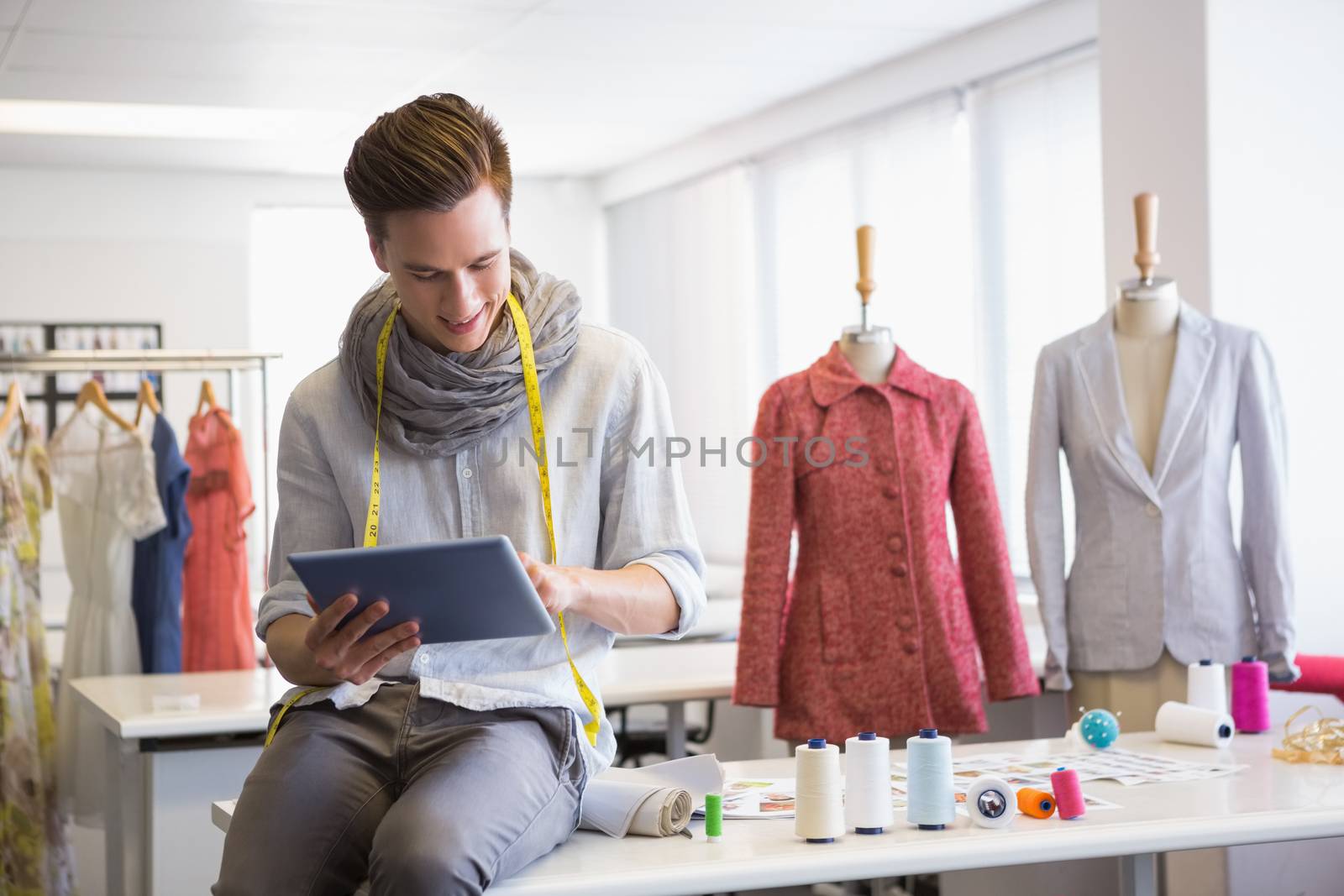 Fashion student working on tablet computer by Wavebreakmedia