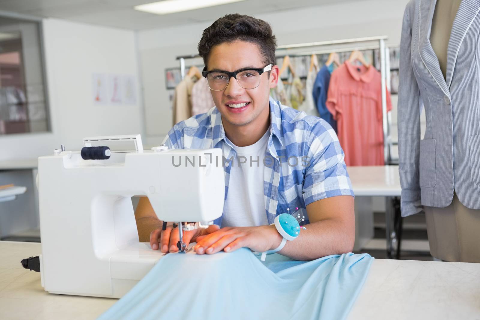 Fashion student using sewing machine by Wavebreakmedia