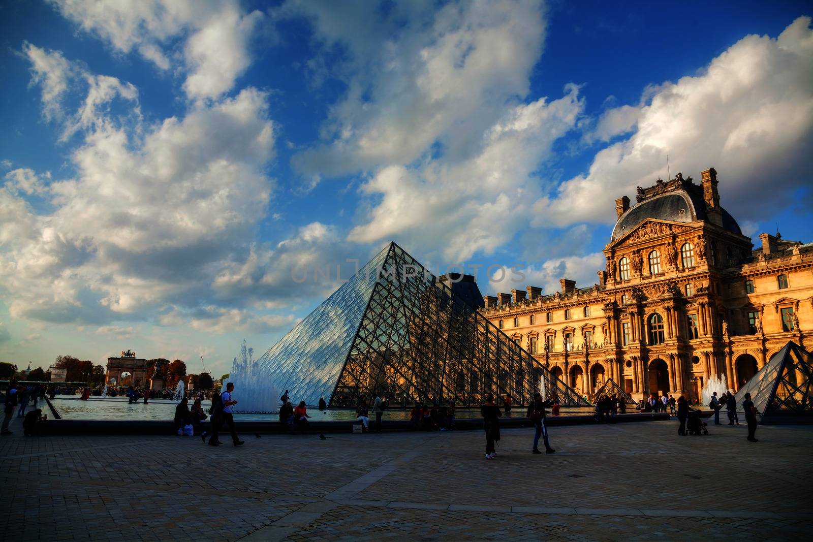 PARIS - OCTOBER 9: The Louvre Pyramid on October 9, 2014 in Paris, France. It serves as the main entrance to the Louvre Museum. Completed in 1989 it has become a landmark of Paris.