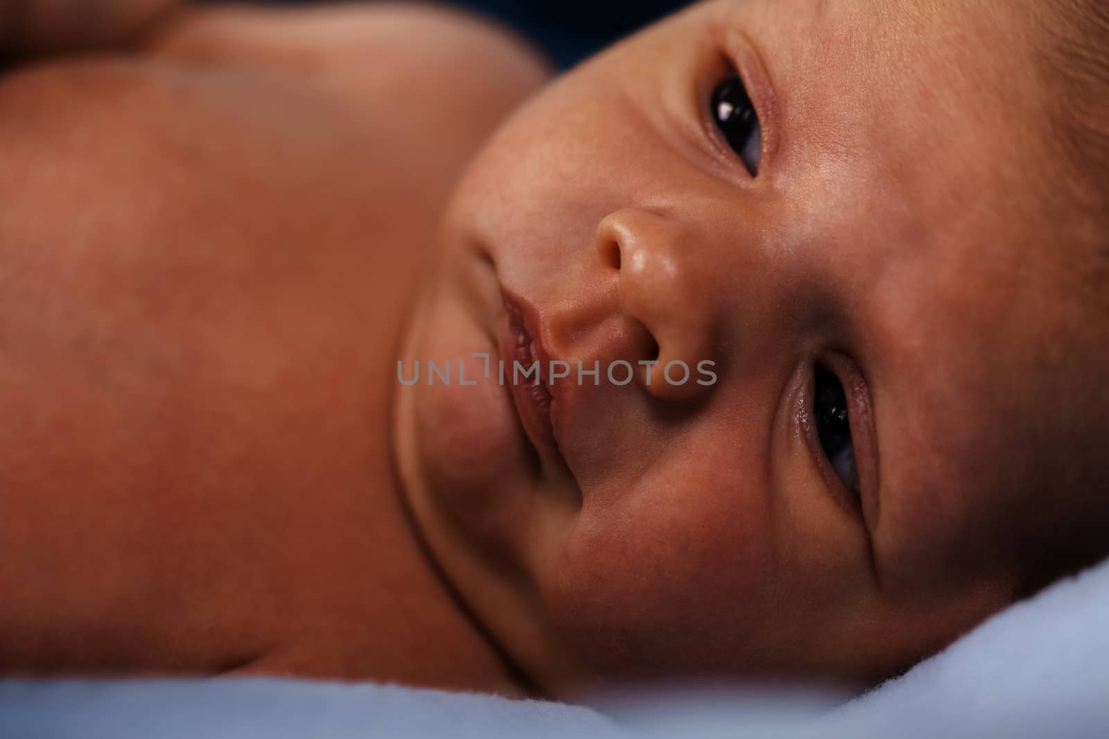 Close up Cute White New Born Baby Lying in Prone on White Cotton Cloth with Open Mouth