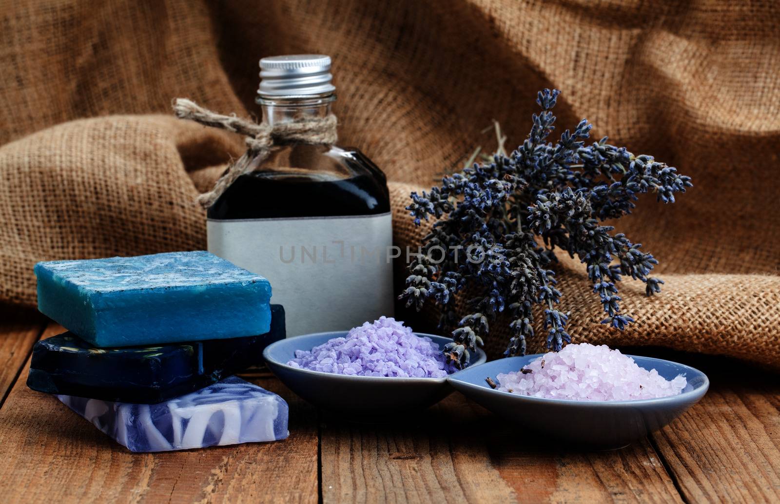 Homemade Soap with Lavender Flowers and Sea Salt, on wooden back by motorolka