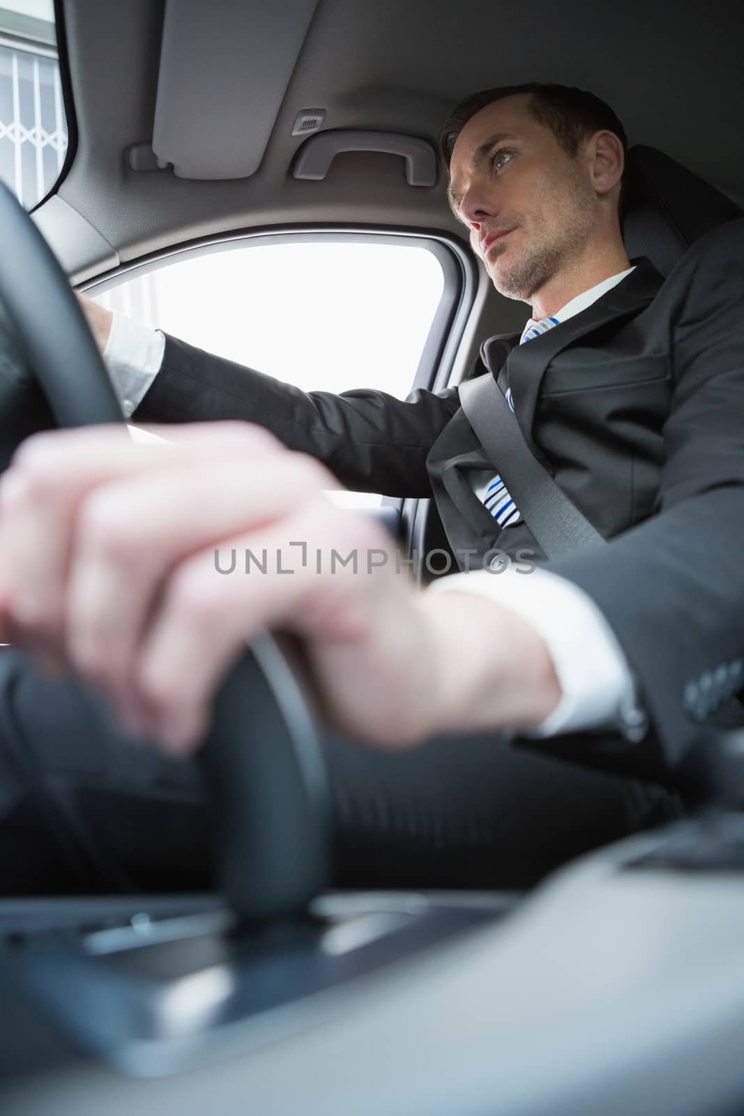 Handsome businessman in the drivers seat in his car