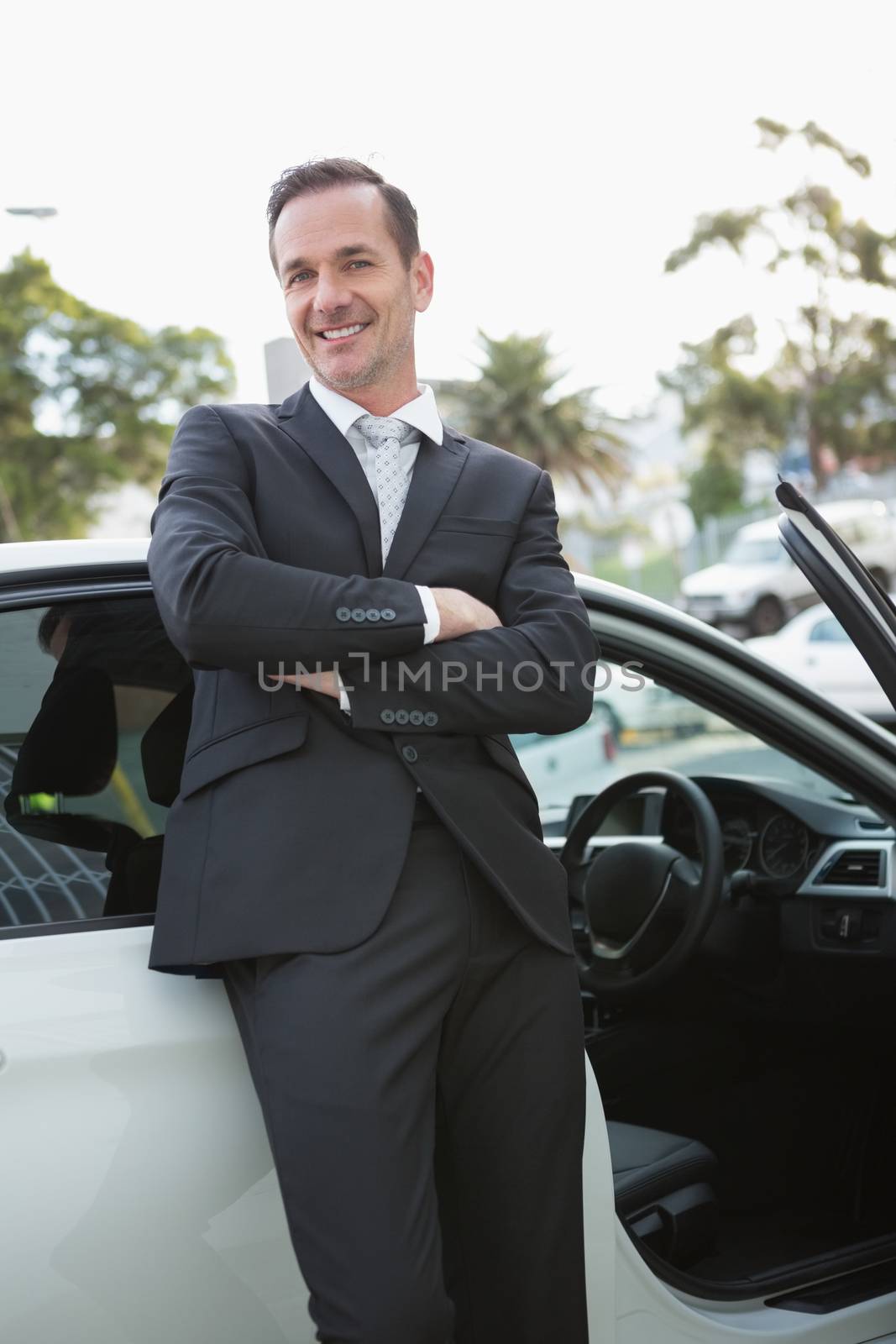 Handsome businessman smiling at camera by Wavebreakmedia