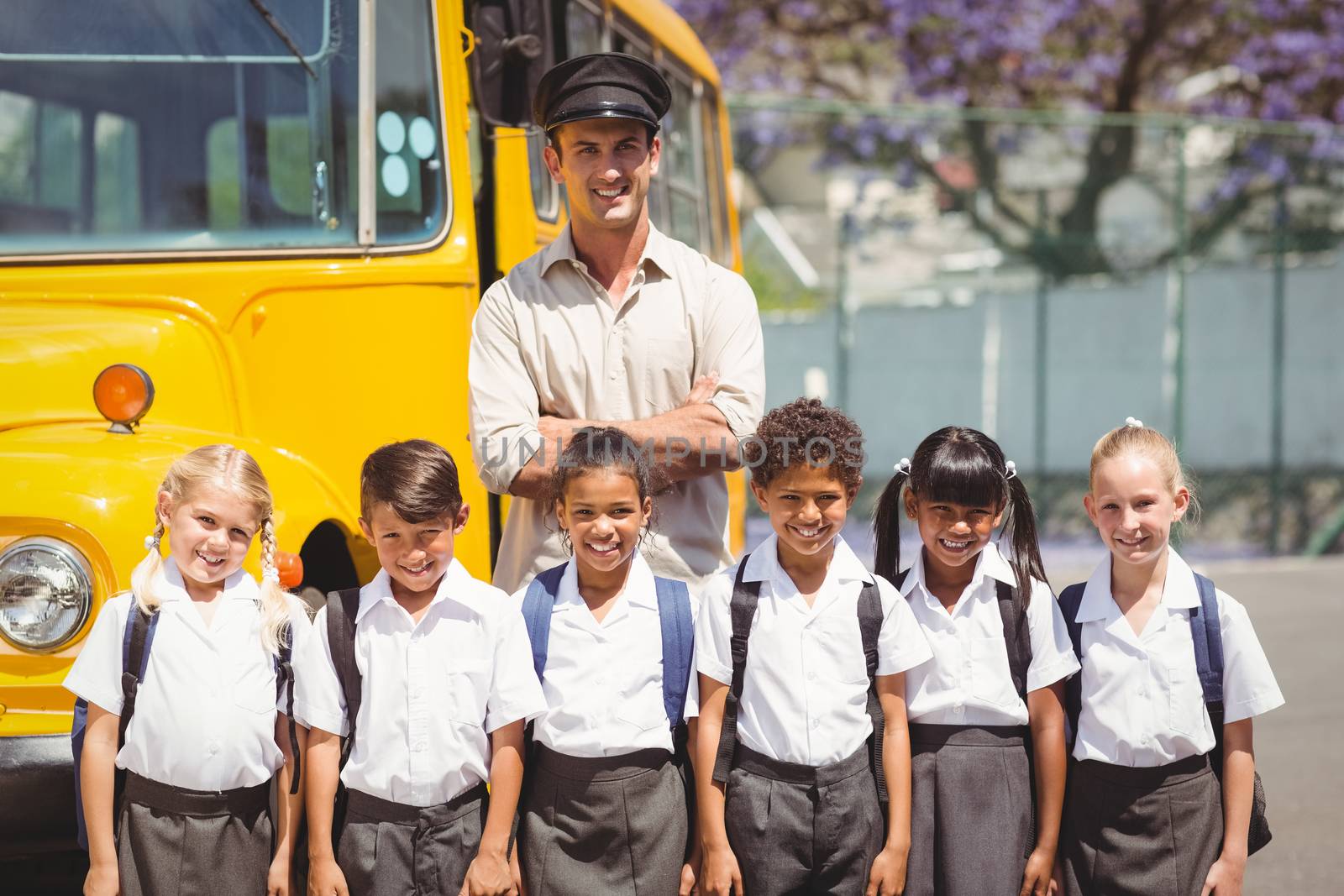 Cute pupils with their school bus driver by Wavebreakmedia