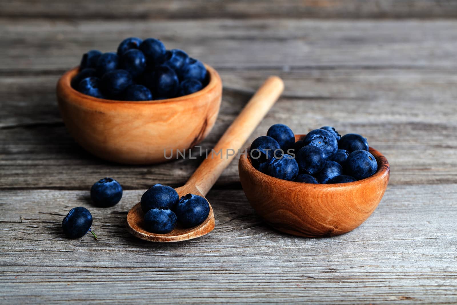 Blueberries on a wooden spoon by motorolka