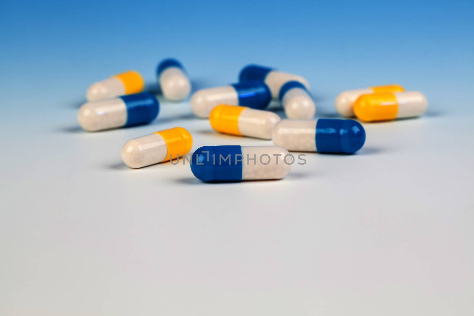 Colorful medical capsules on white background.