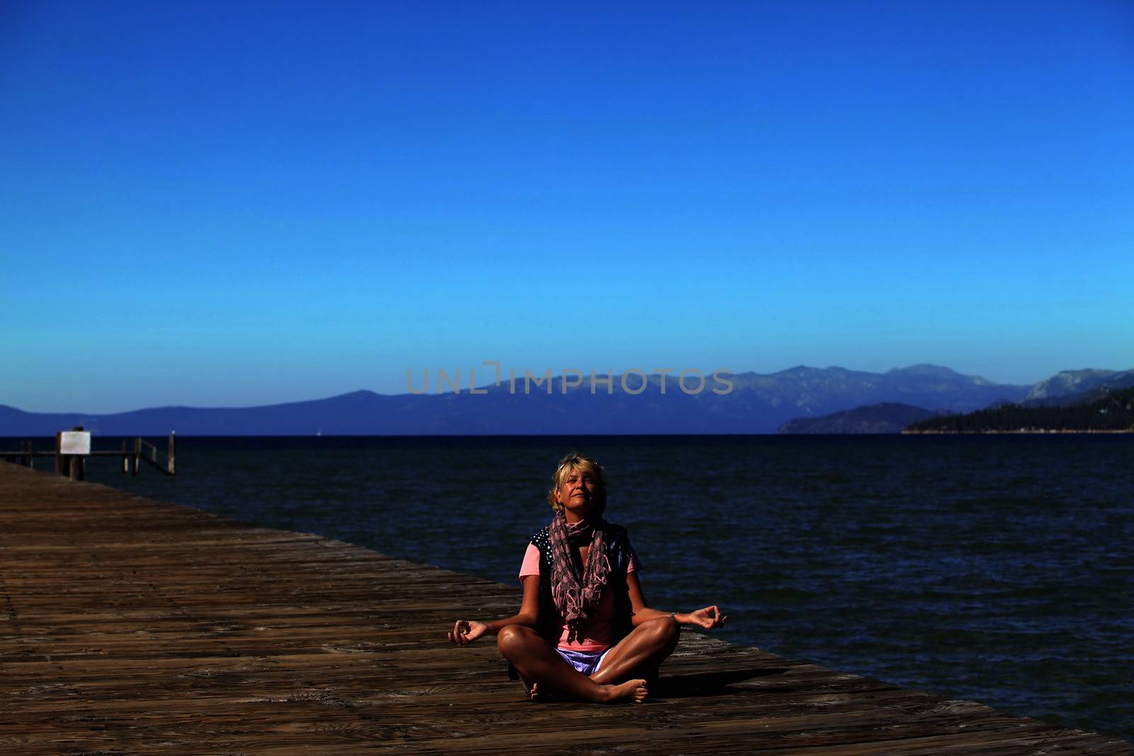 Meditation girl yoga on the beach on Tahoe, California
