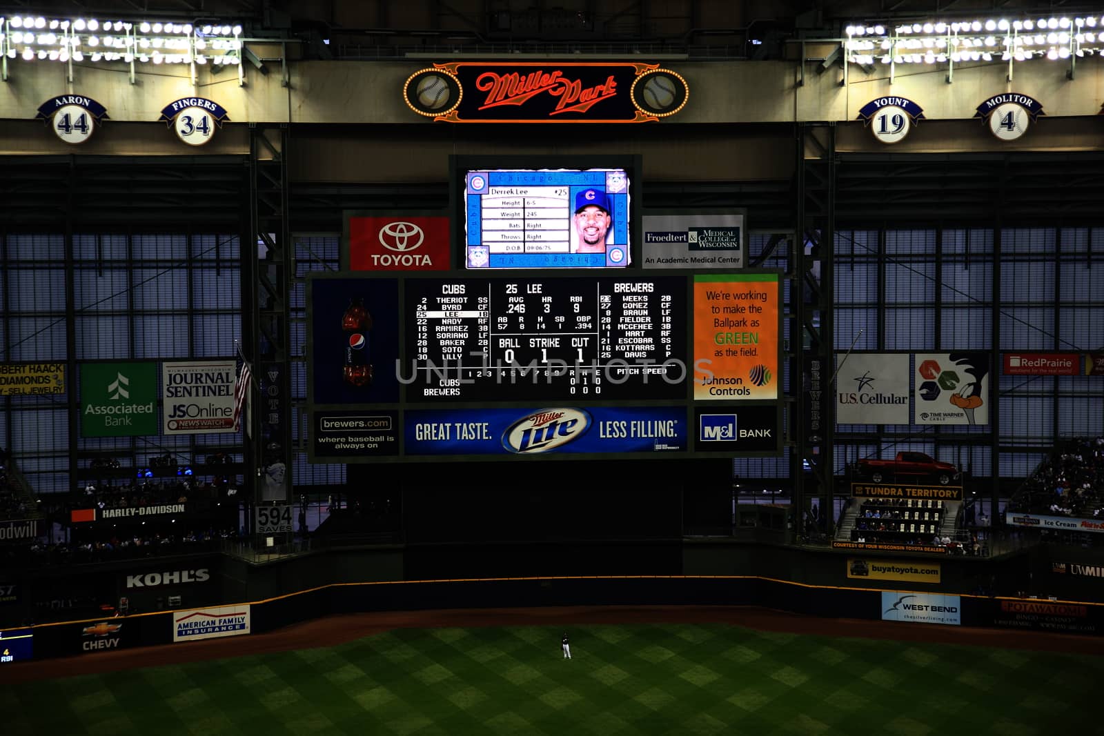 Brewers scoreboard and outfield during a baseball game at Miller Park against the Chicago Cubs under a closed dome.