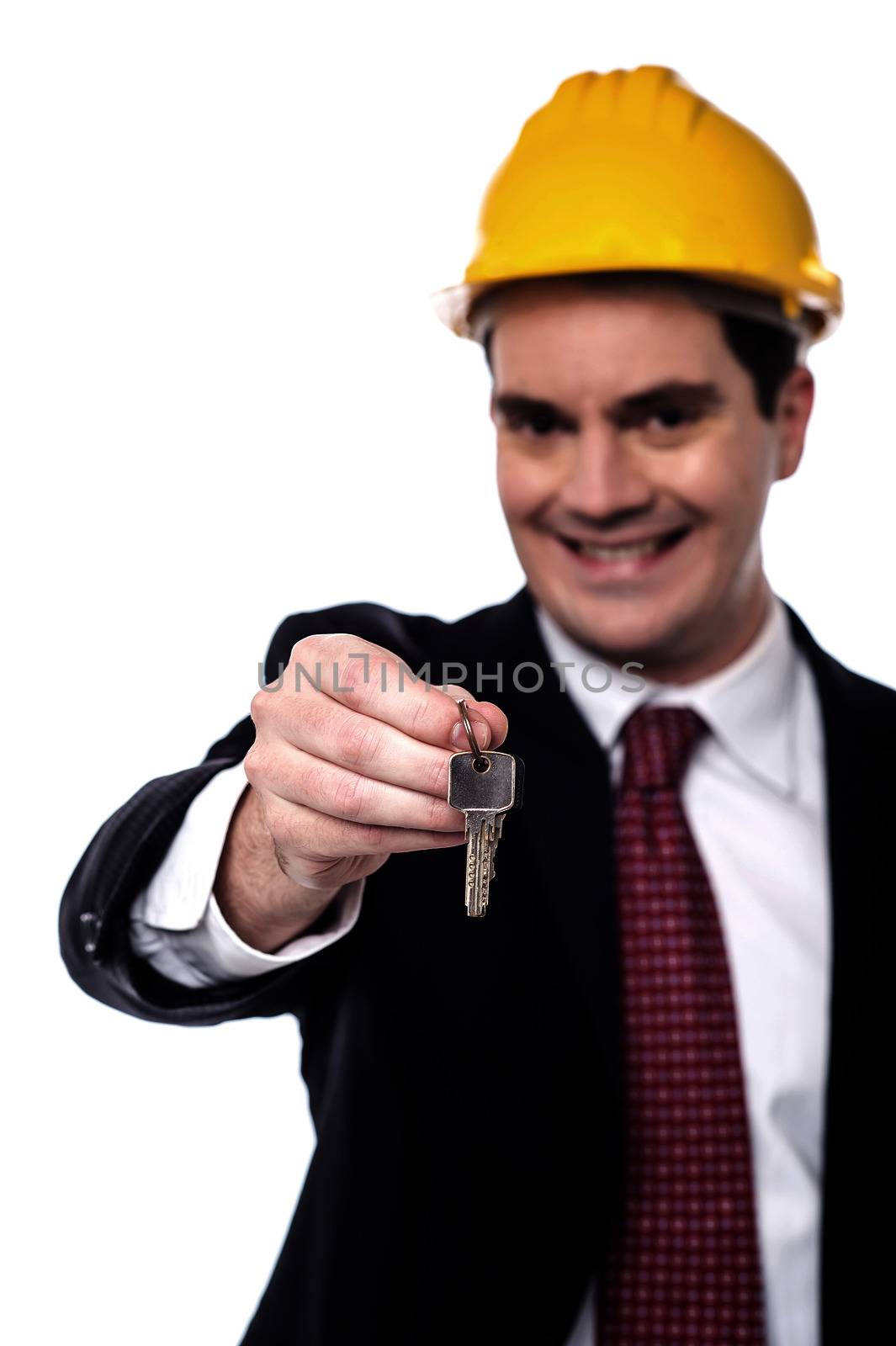 Happy male architect giving new house key
