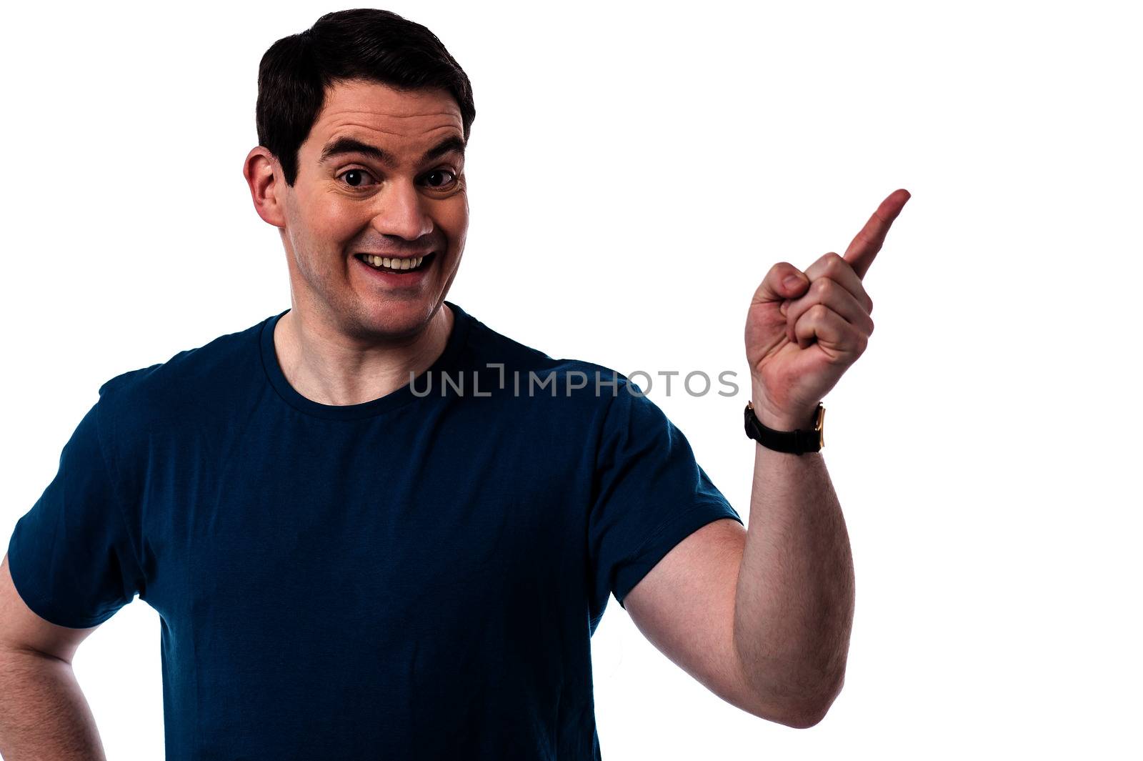 Excited man pointing his finger at copy space