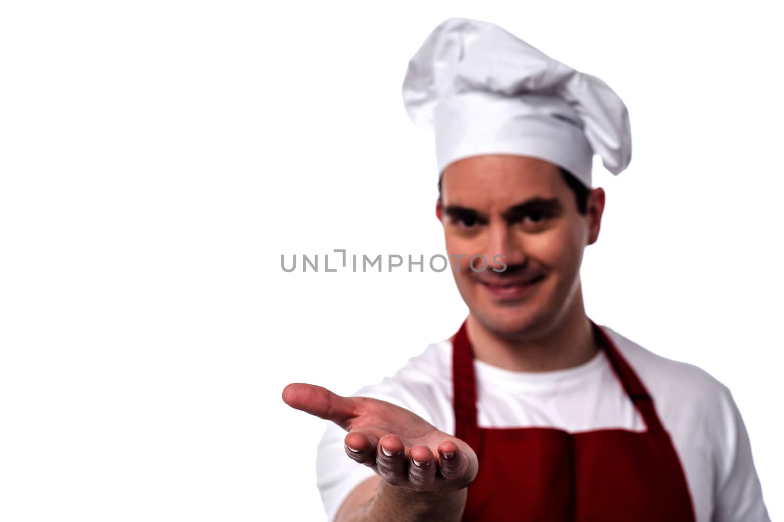 Happy male chef showing his palm to camera 