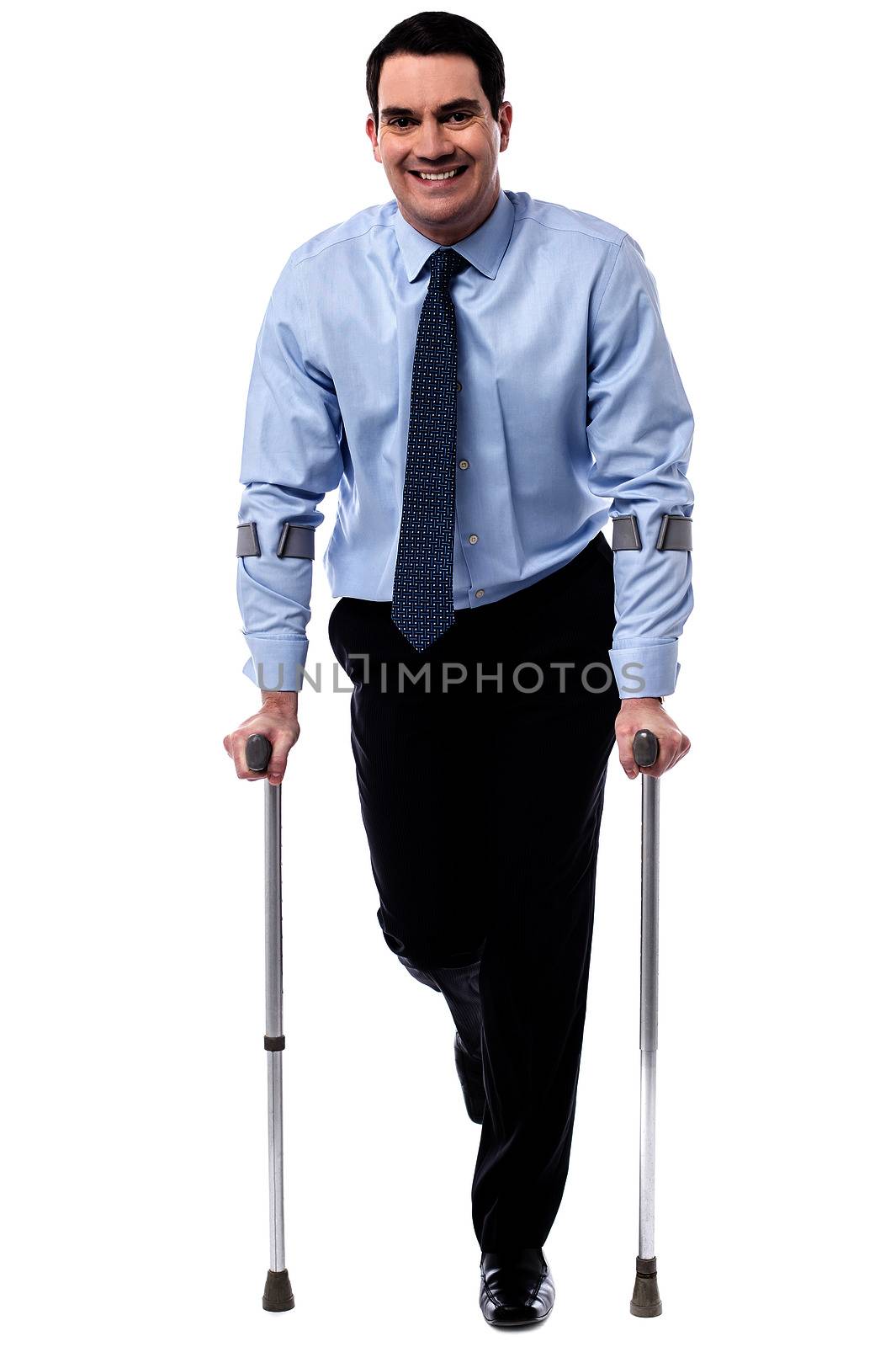 Executive man trying to walk with crutches