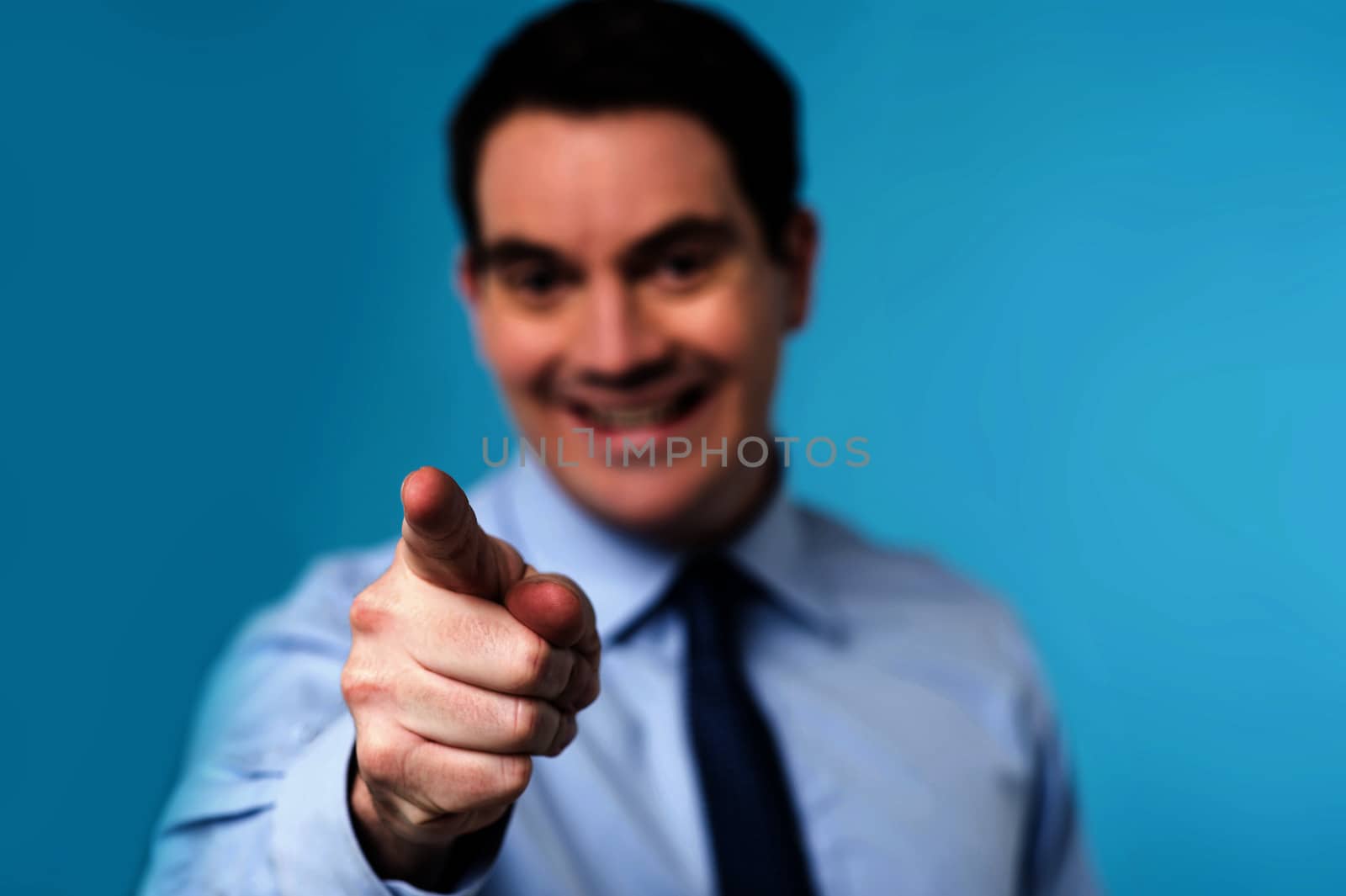 Male executive pointing his finger towards camera