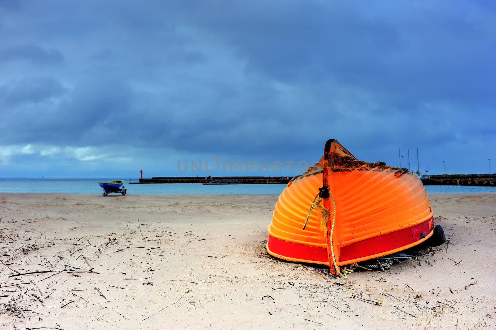 Wooden boat inverted bottom up on the sandy beach