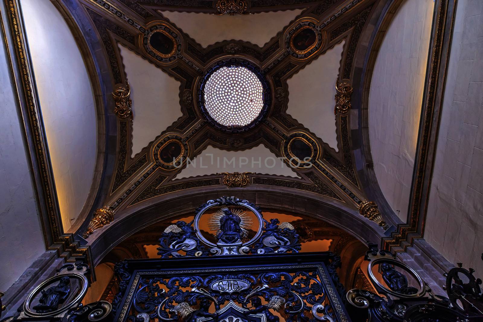 Small Chapel Gate Dome Old Basilica Shrine of Guadalupe Mexico City Mexico. Also known as Templo Expiatorio a Cristo Rey.  Basilica construction was started in 1531, finished in 1709.  This is the basilica is the location where the Virgin Mary appeared to the Meixcan peasant Juan Diego.  The old Basilica is where Juan Diego's original cloak with the picture of the Virgin Mary first appeared. 