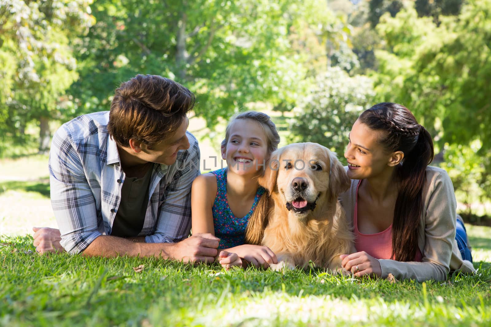 Happy family with their dog in the park by Wavebreakmedia