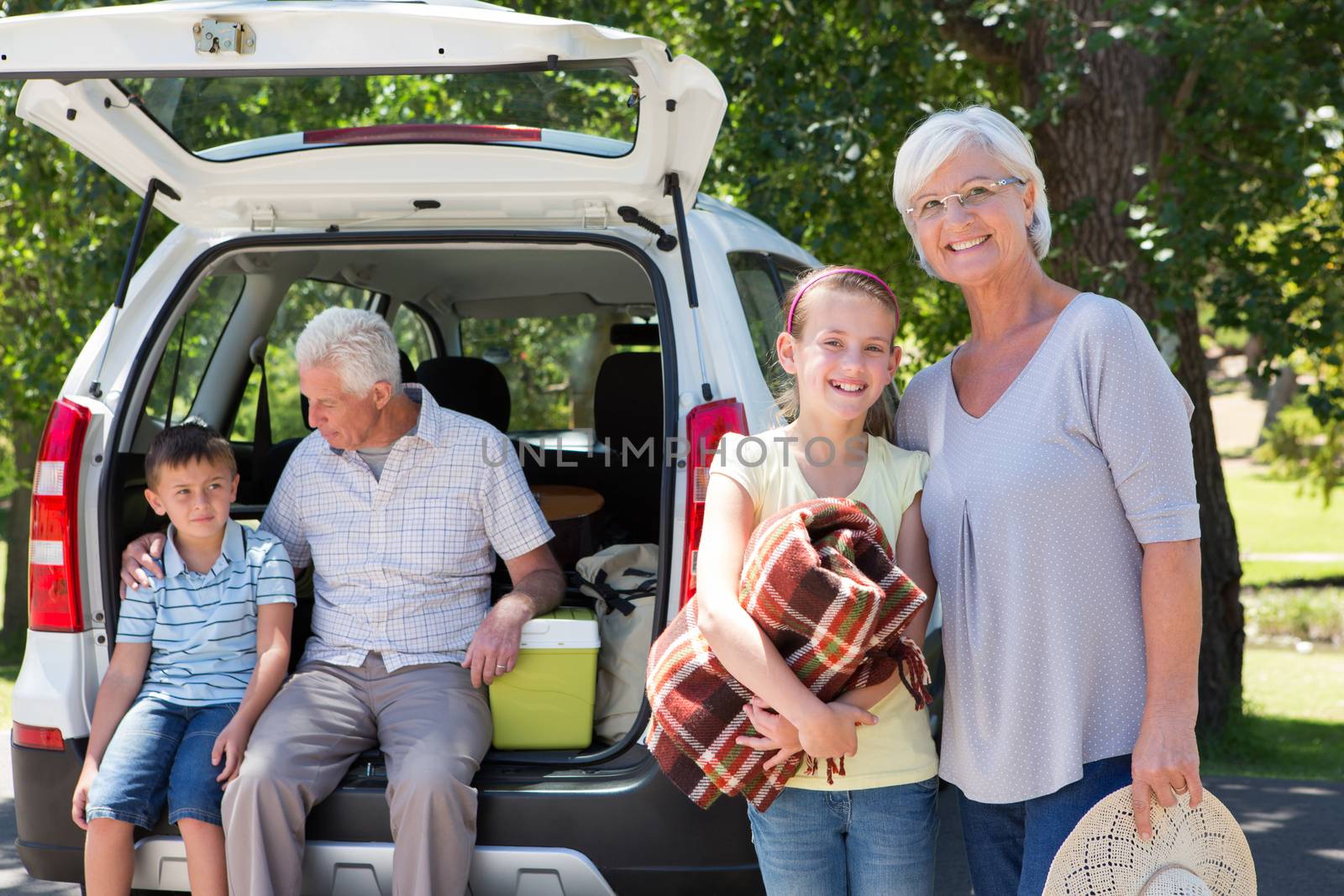 Grandparents going on road trip with grandchildren on a sunny day