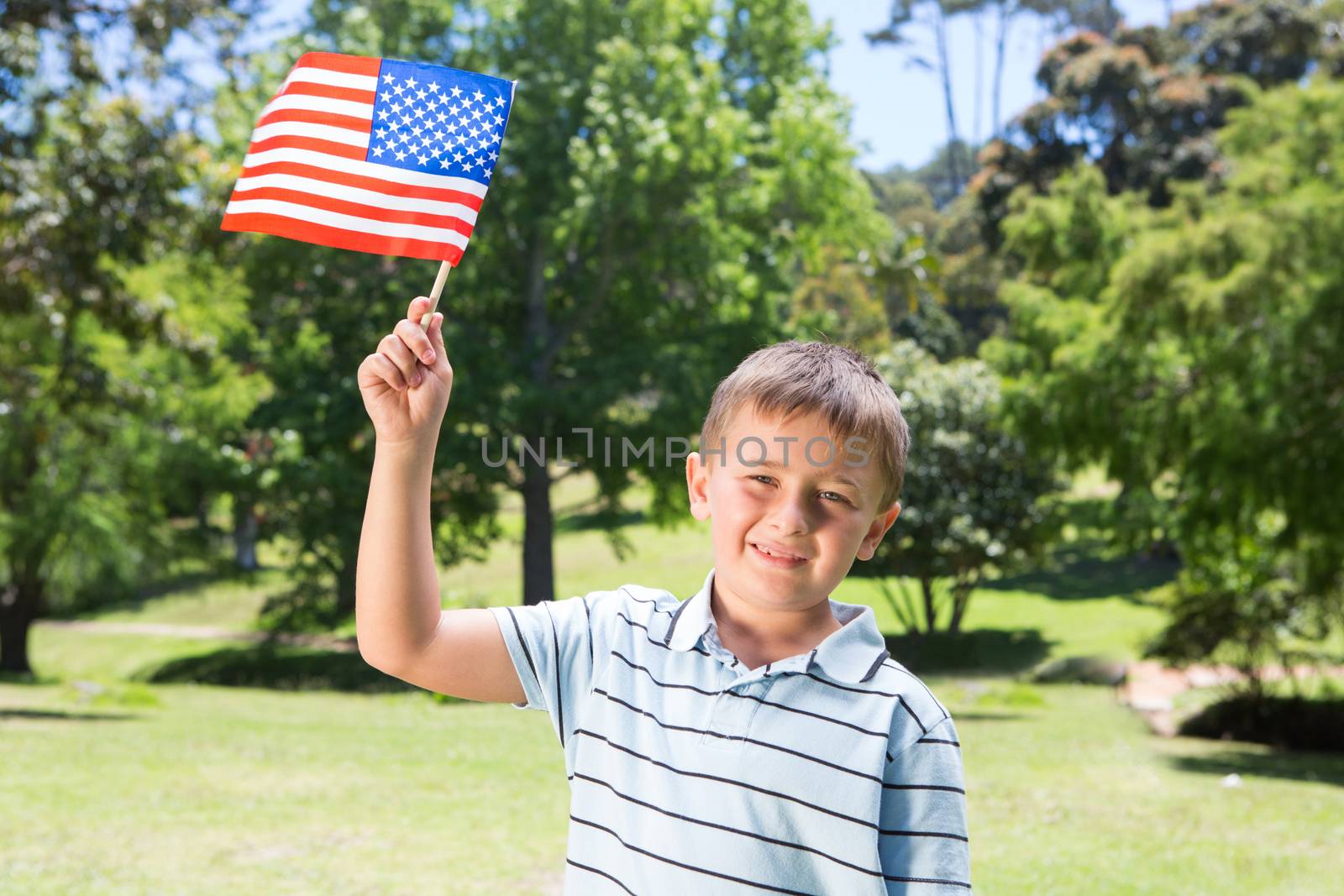Little boy waving american flag by Wavebreakmedia