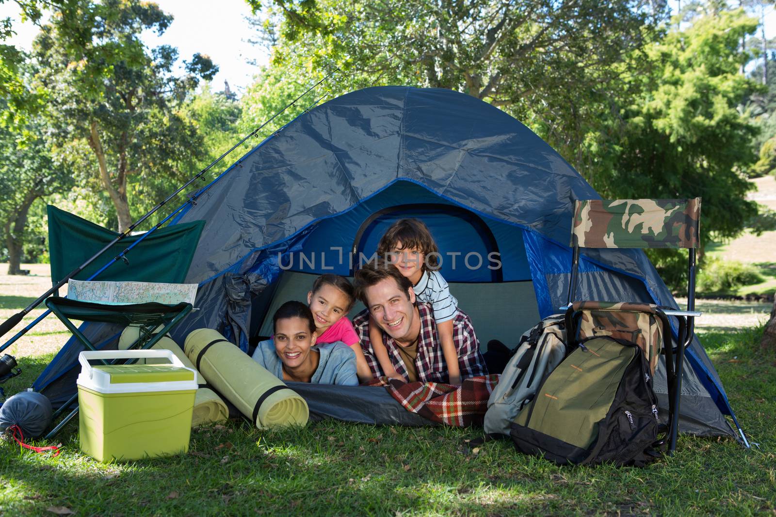Happy family on a camping trip in their tent by Wavebreakmedia