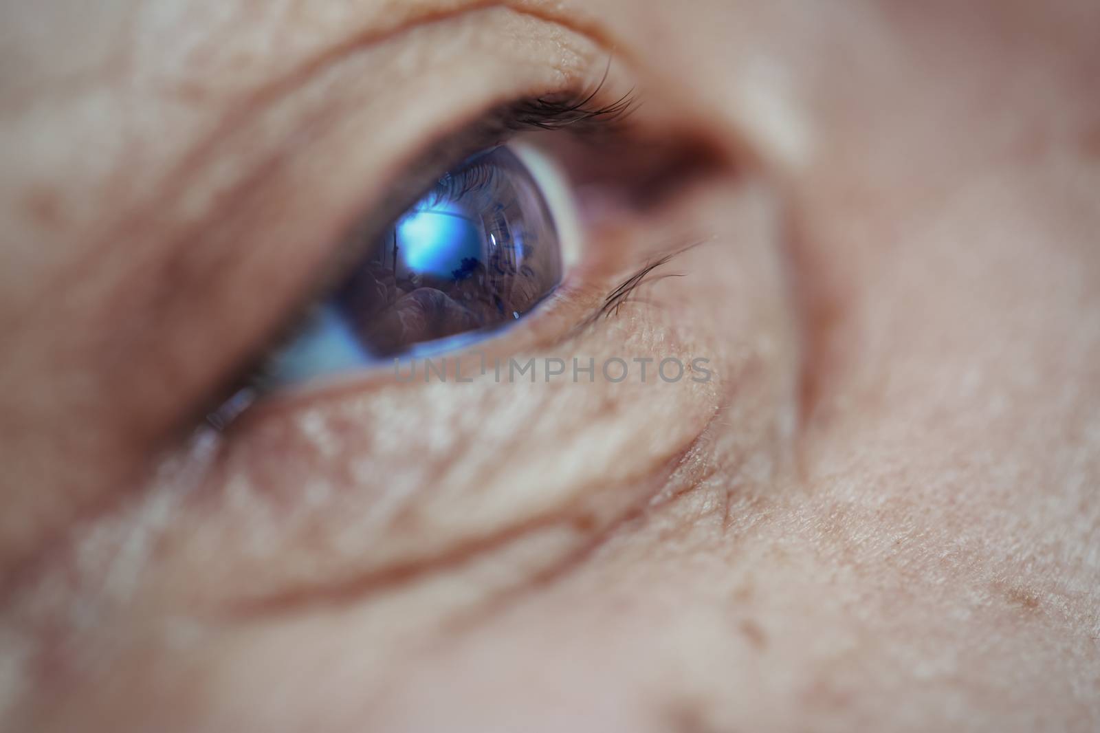 Close-up view on the eye of senior man. Horizontal photo