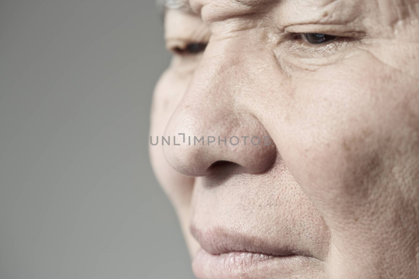 Face of elderly man looking away. Horizontal photo