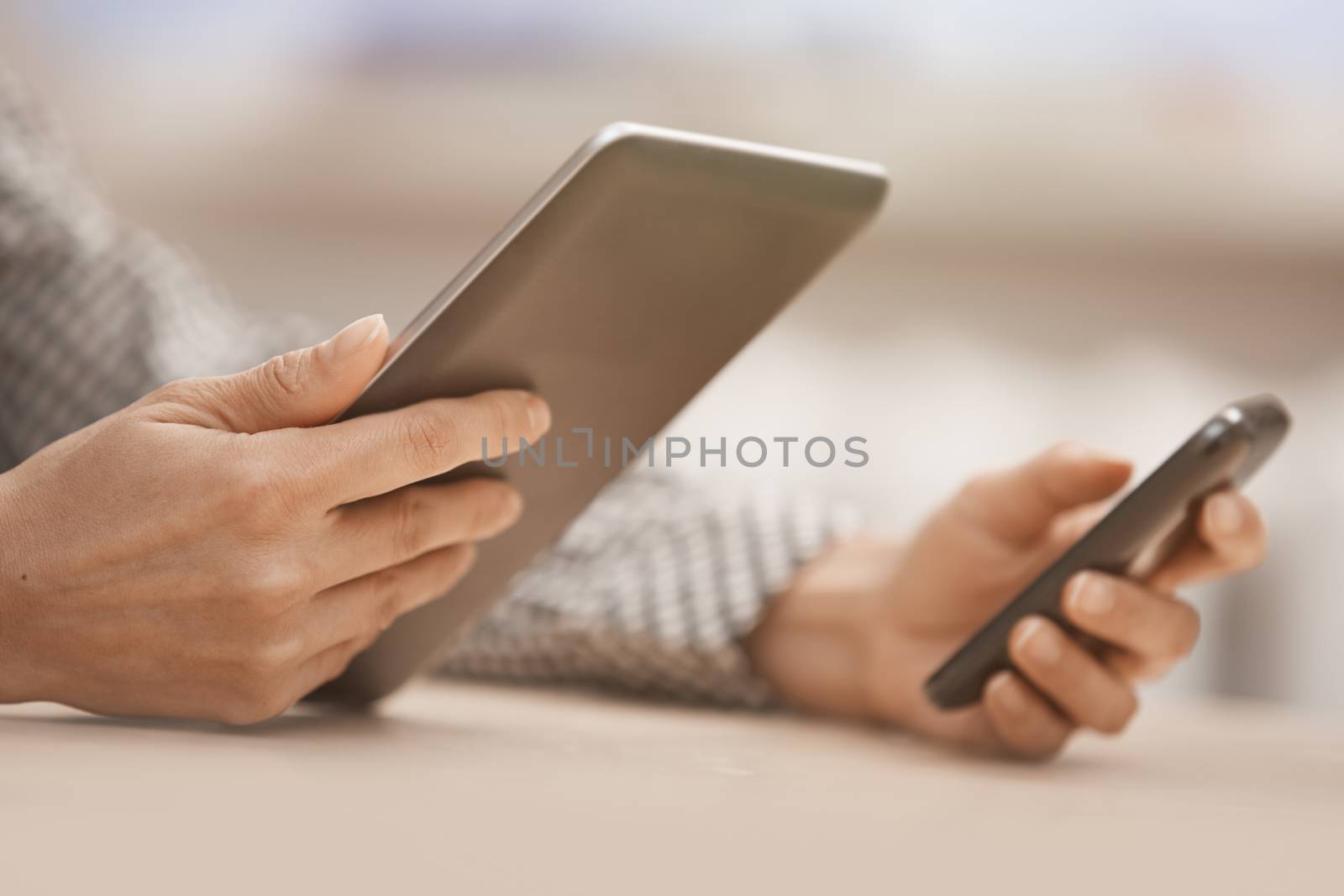 Businesswoman at office with digital tablet and smartphone