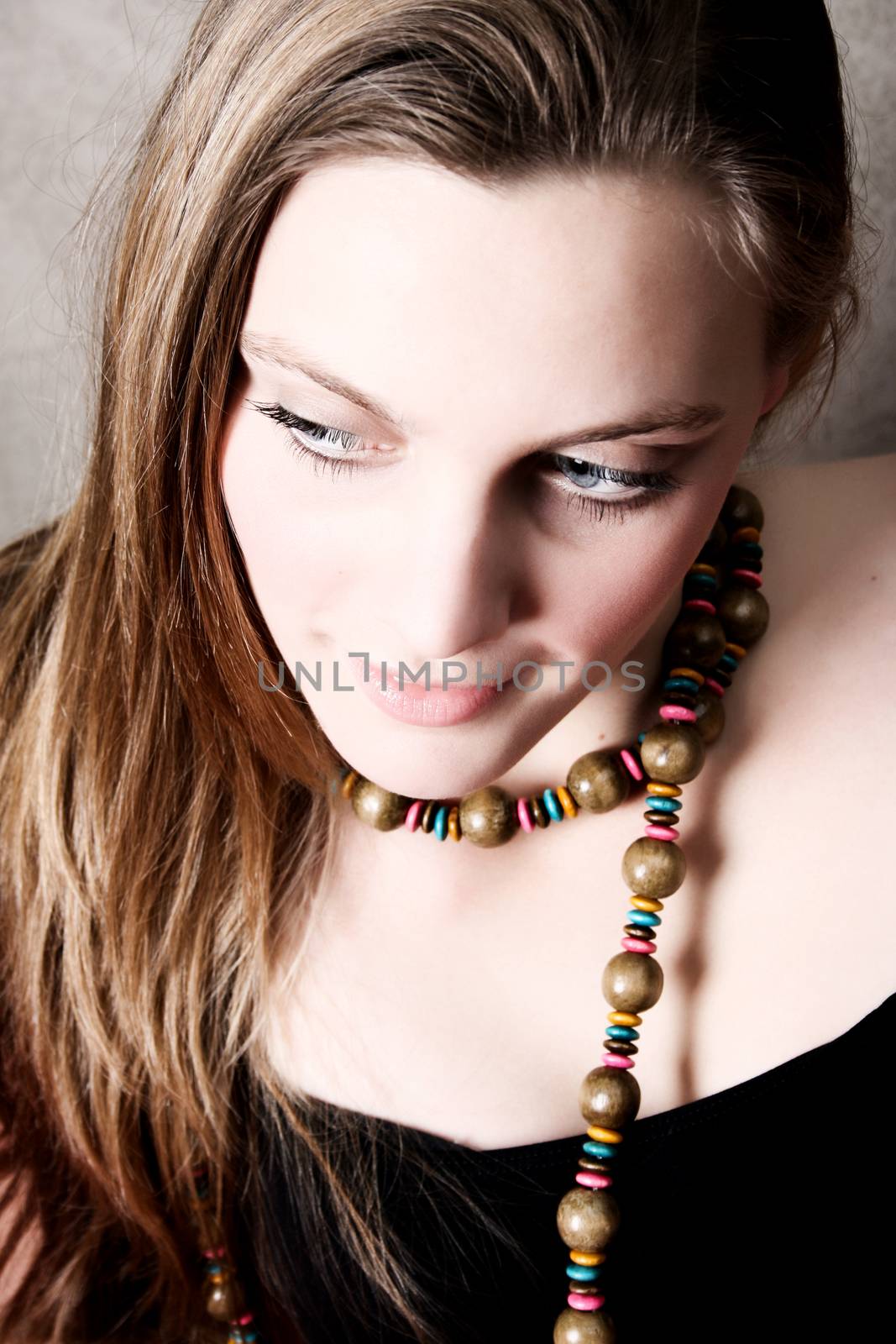 Beautiful female model wearing wooden beads and black top