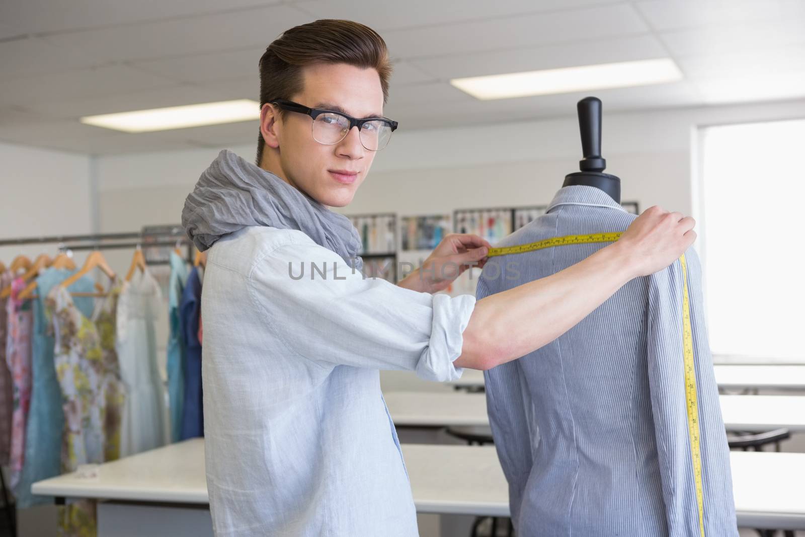 Fashion student working on mannequin by Wavebreakmedia