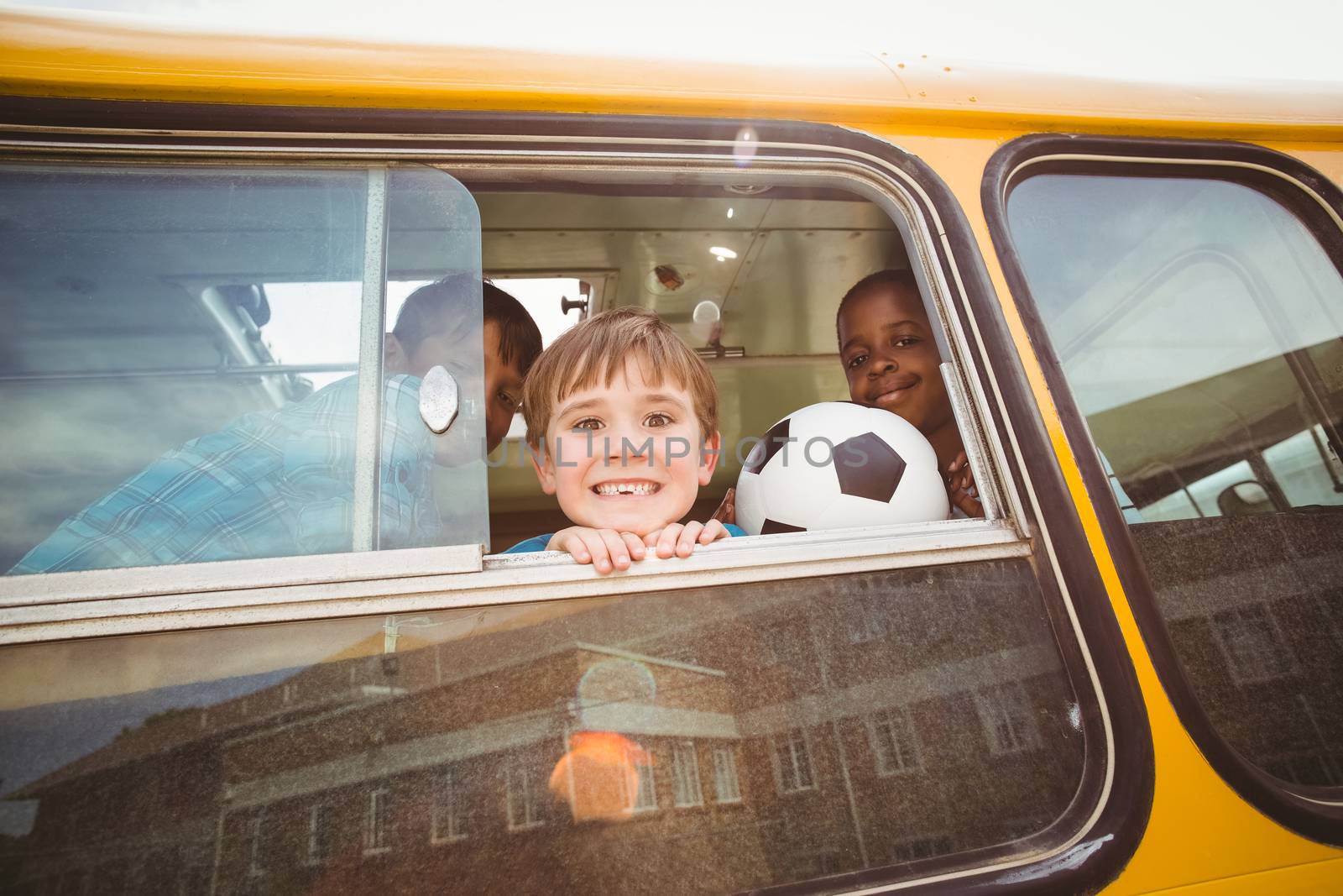 Cute pupils smiling at camera in the school bus by Wavebreakmedia