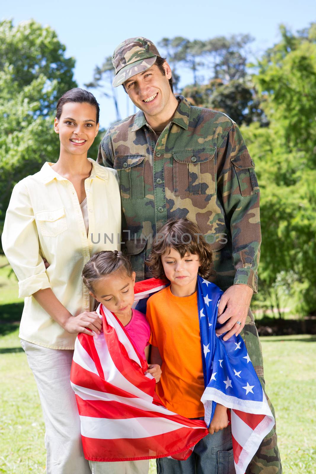 American soldier reunited with family on a sunny day