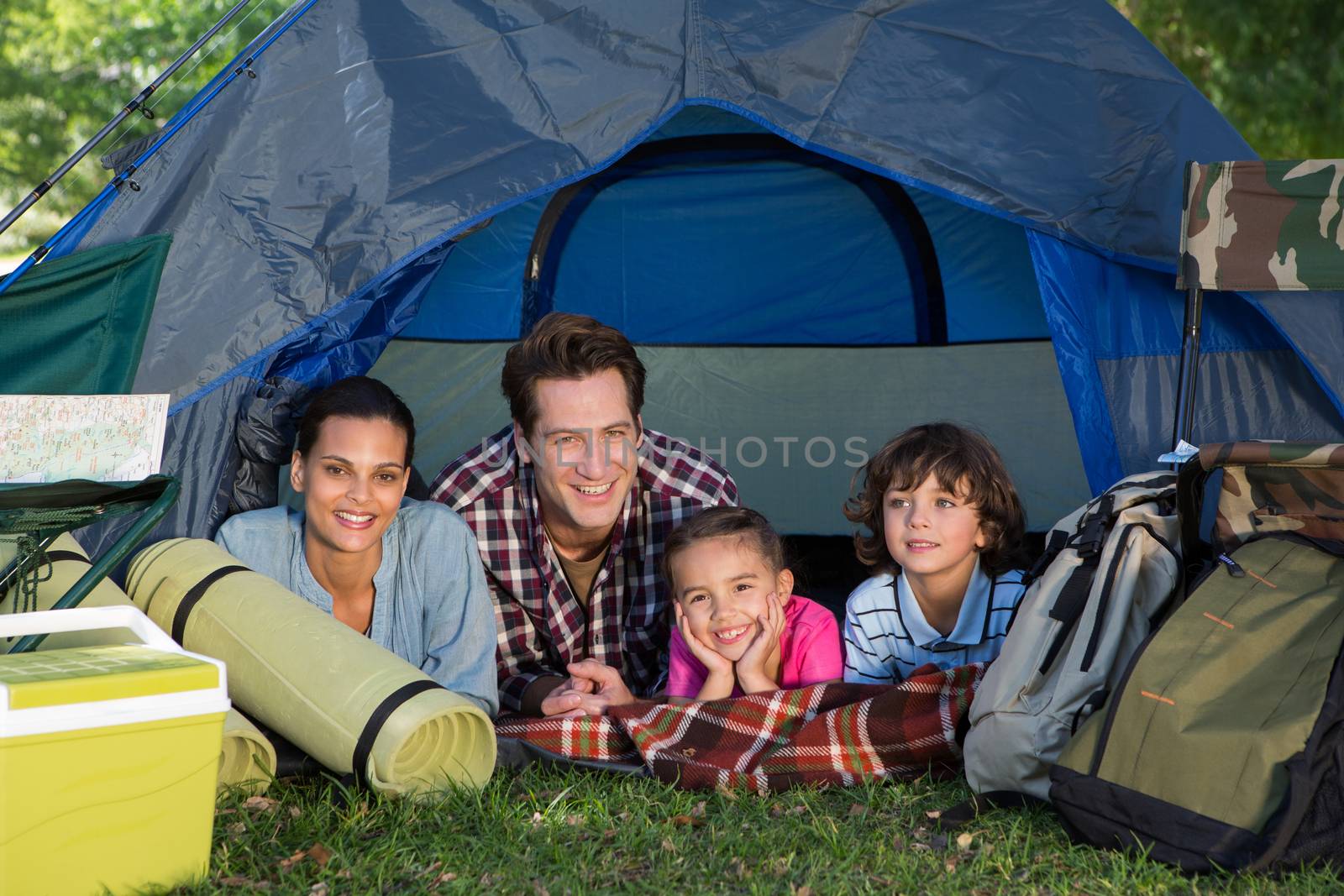 Happy family on a camping trip in their tent by Wavebreakmedia