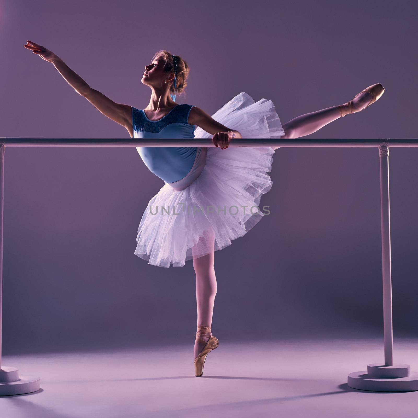 classic ballerina posing at ballet barre by master1305