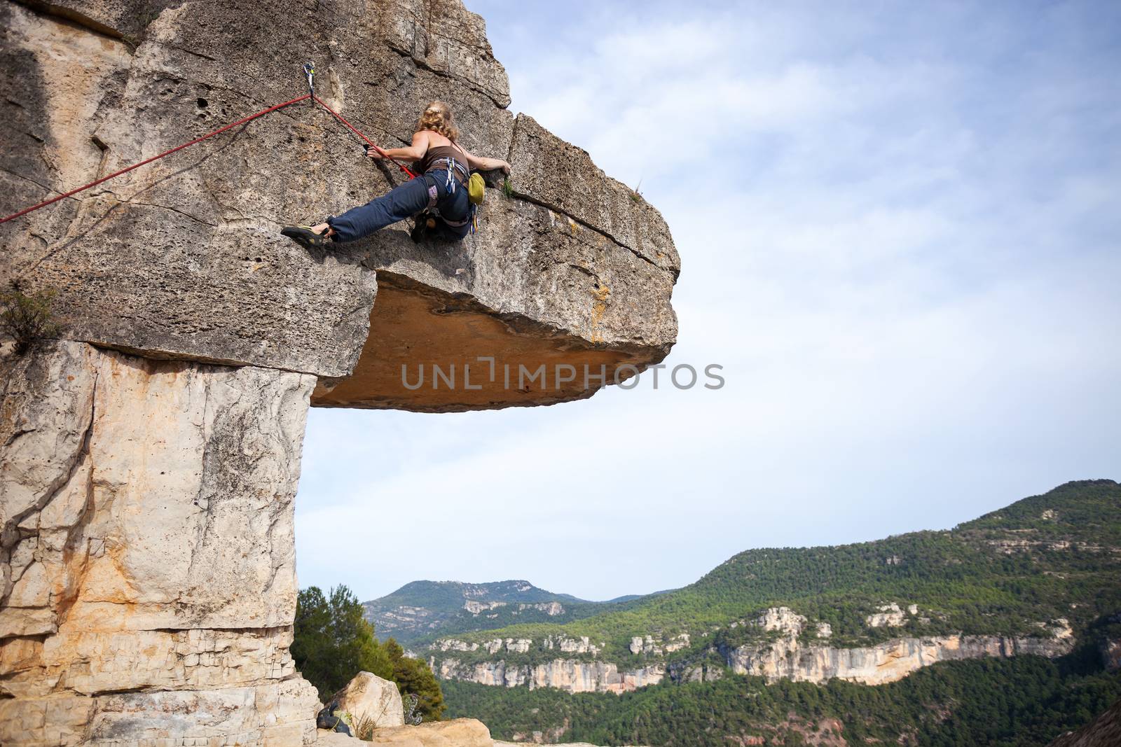 Young female climber on a cliff by photobac