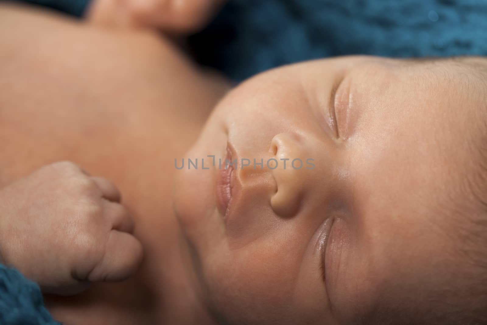 Close up Cute White New Born Baby Lying in Prone on White Cotton Cloth with Open Mouth