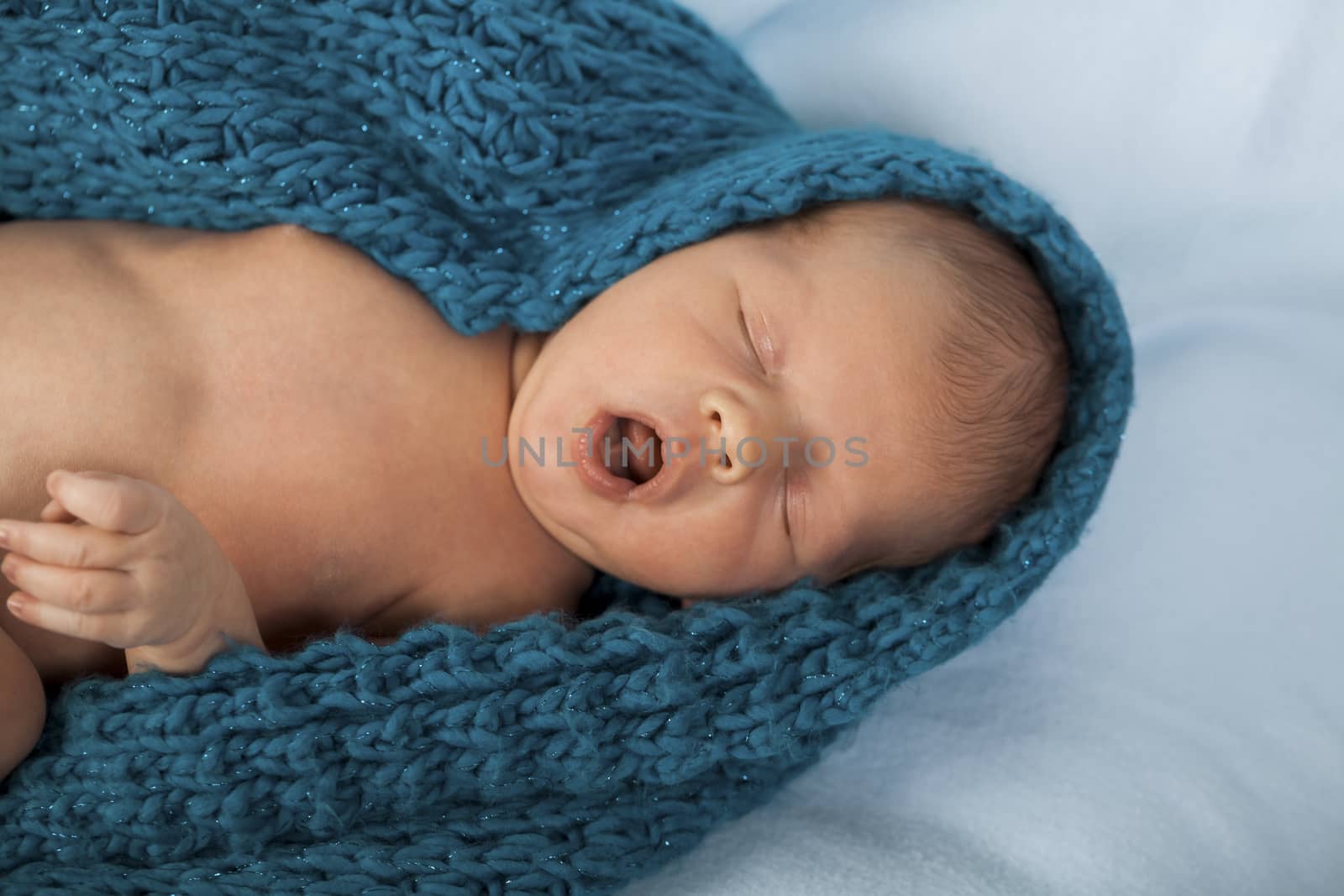 Close up Cute White New Born Baby Lying in Prone on White Cotton Cloth with Open Mouth