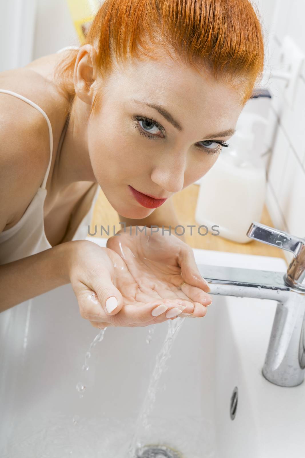 Woman Washing her Face While Looking at the Camera by juniart