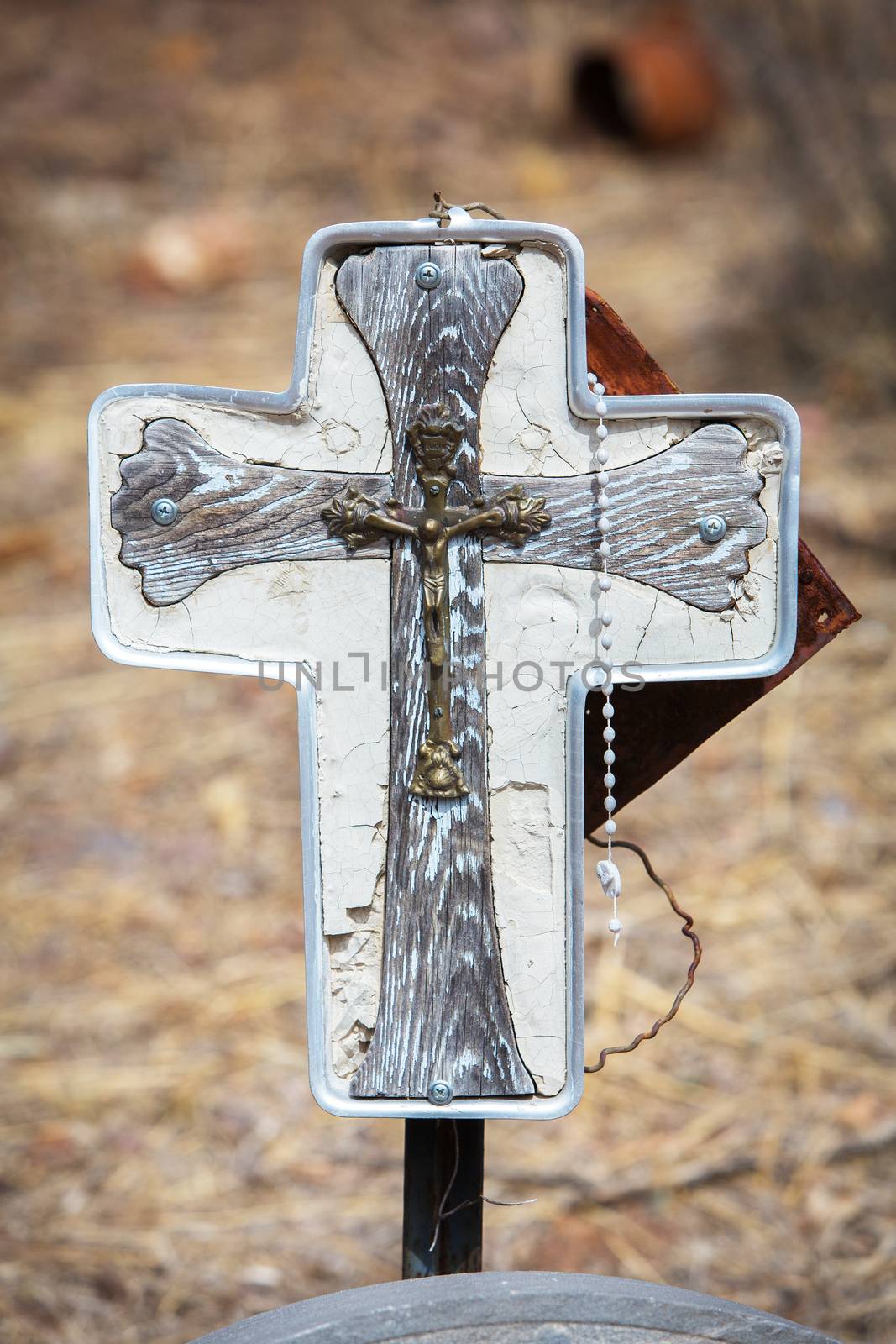 Close up of home made Catholic grave marker with rosary