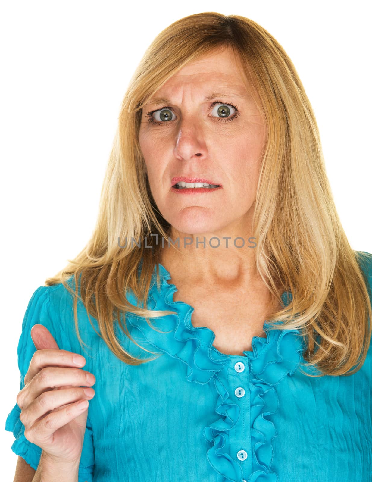Uncomfortable blond mature female with worried expression