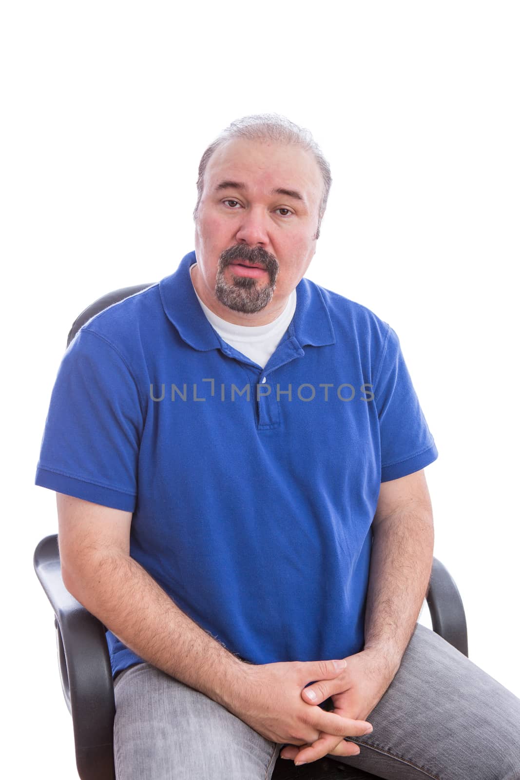 Close up Bearded Middle Age Man, Sitting on a Chair, Looking at the Camera in an Amazed Facial Expression. Isolated on White Background.