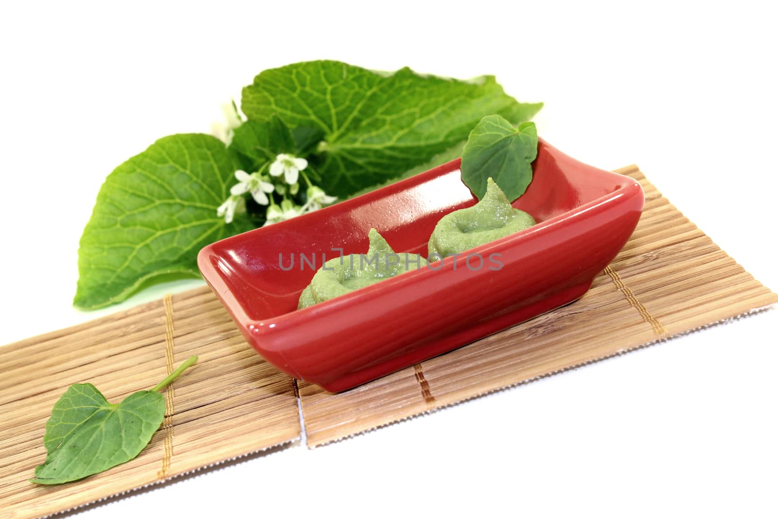 fresh Wasabi with leaf and flower in a red bowl